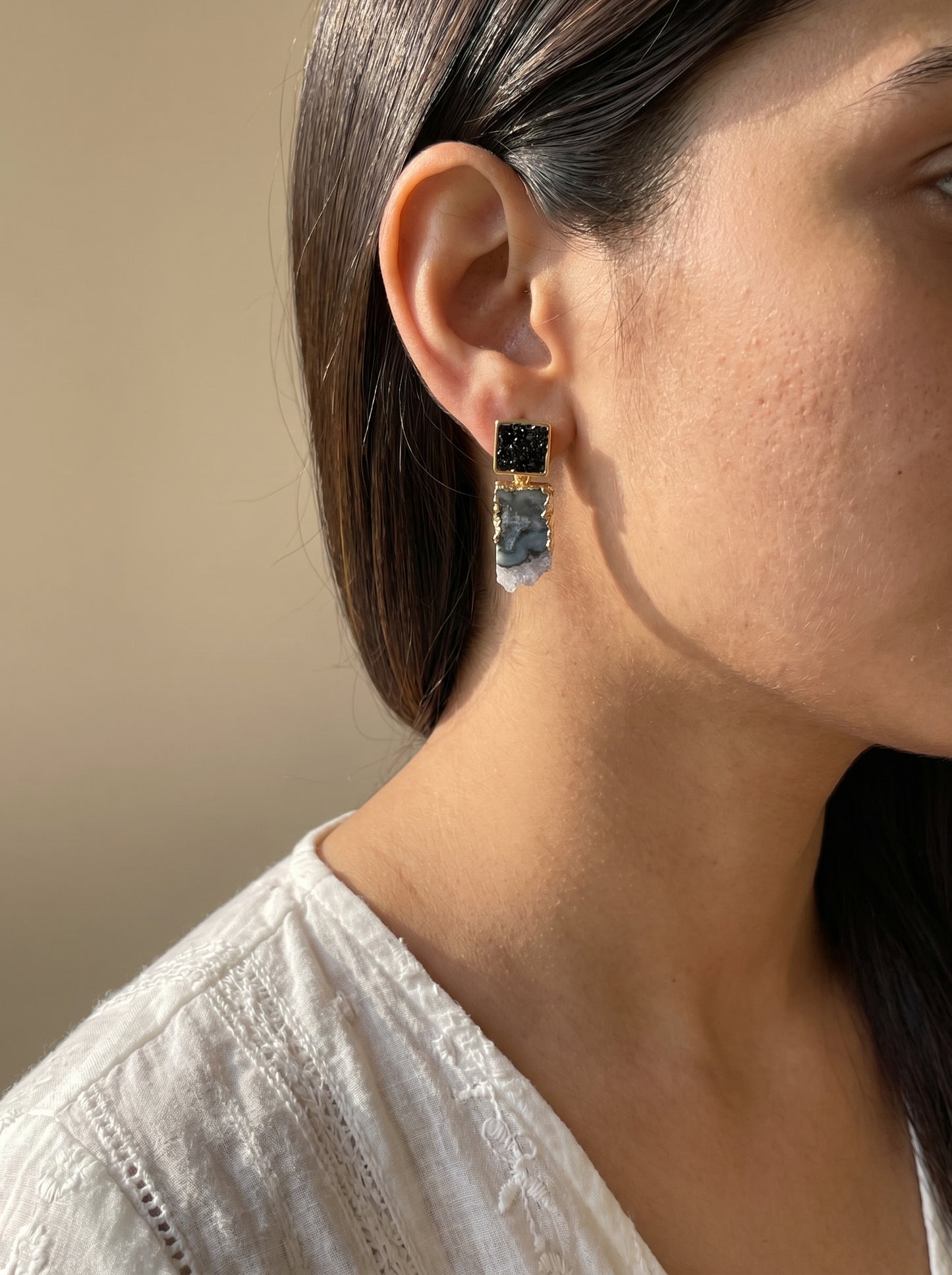 Model wearing black tourmaline and amethyst drop earrings, side profile view
