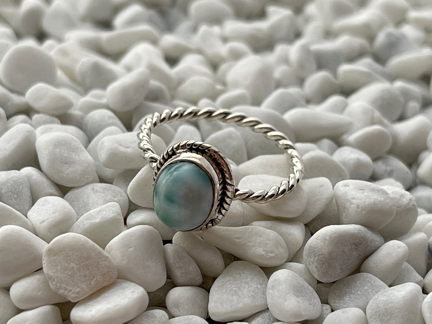 Larimar gemstone Silver ring with a blue stone on pebbles