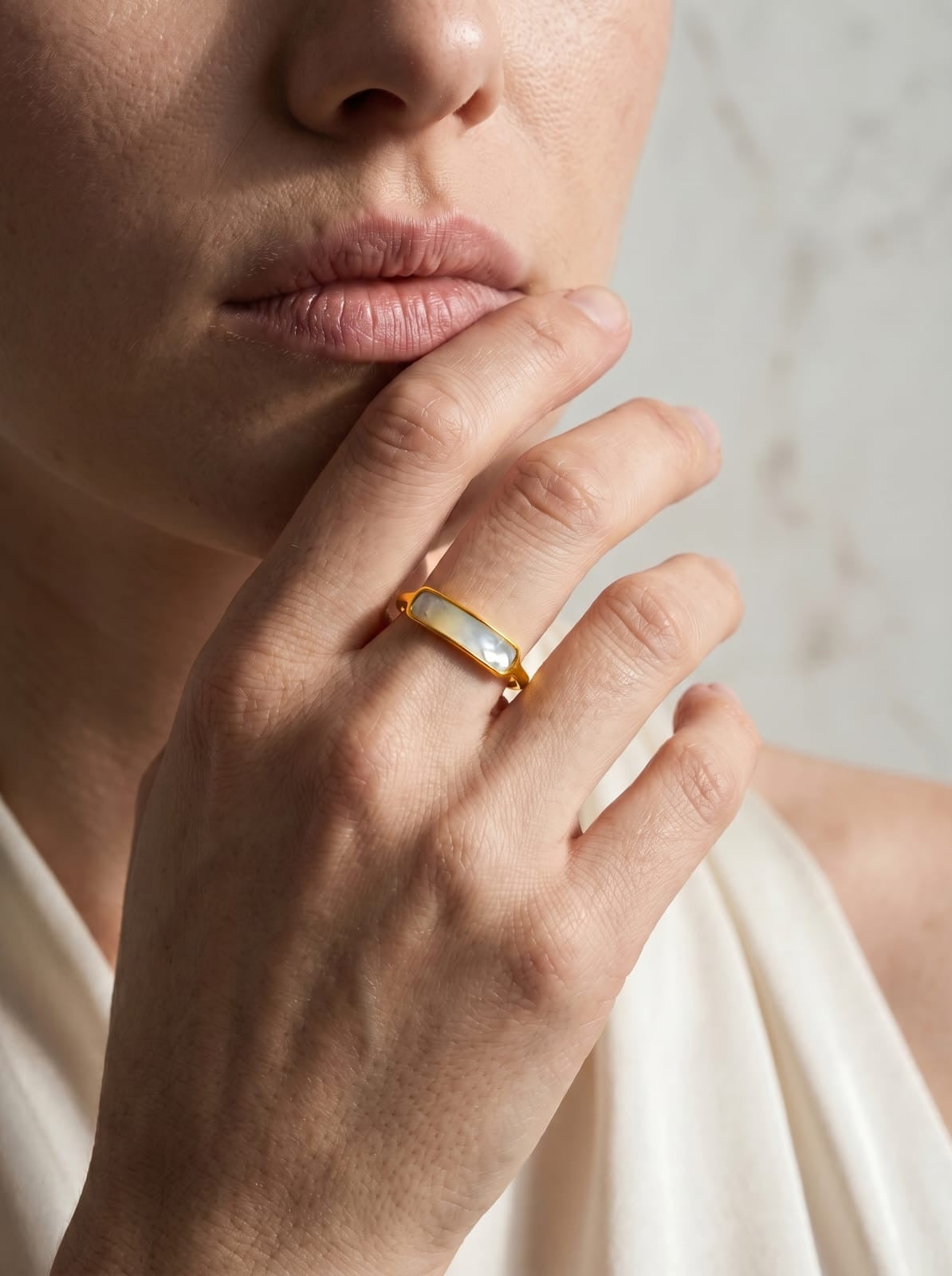 Dainty gold-plated stainless steel ring with rectangular natural shell inlay in soft white and blush pink tones
