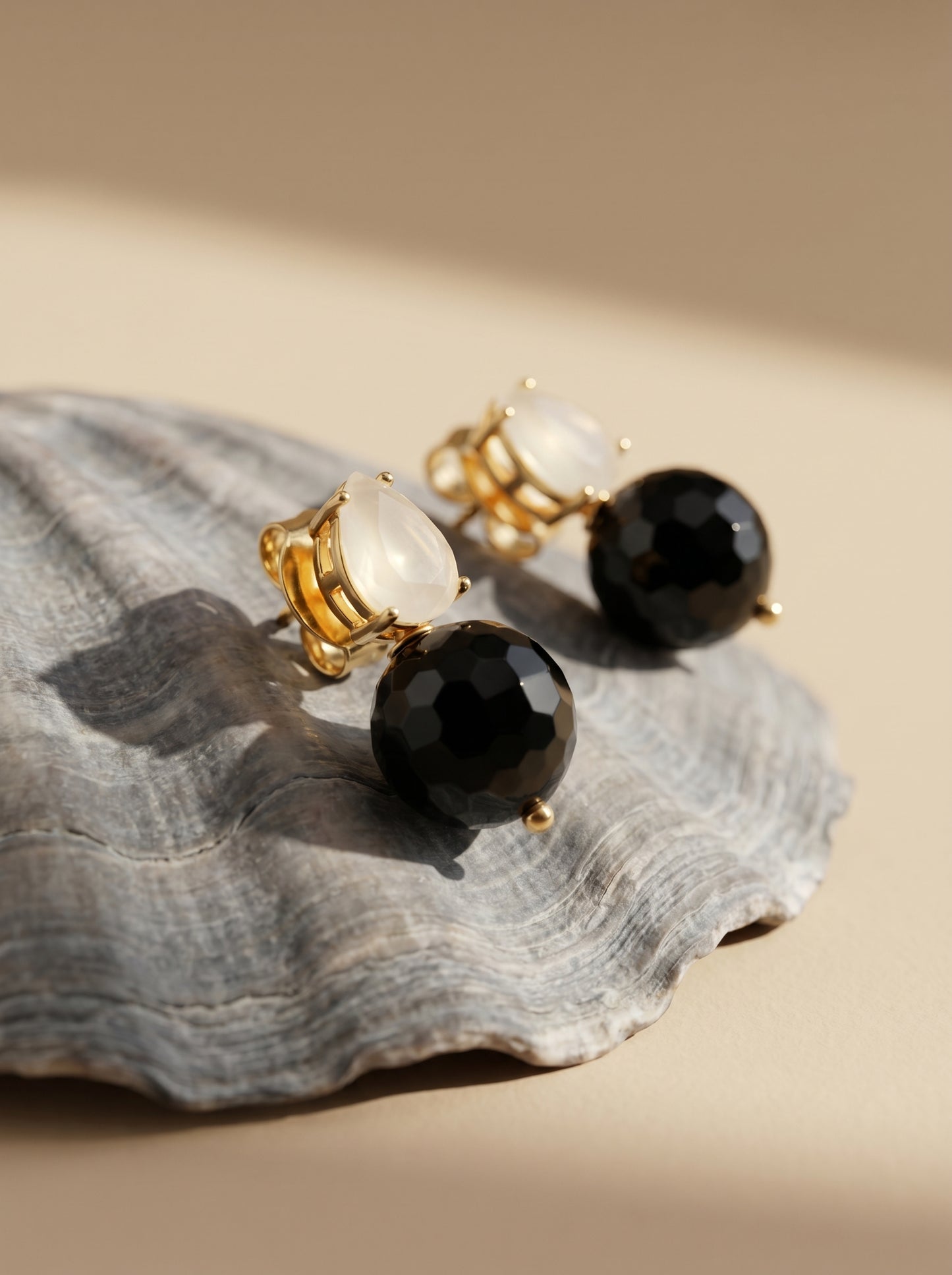 White quartz and black onyx drop earrings flat lay styling shot