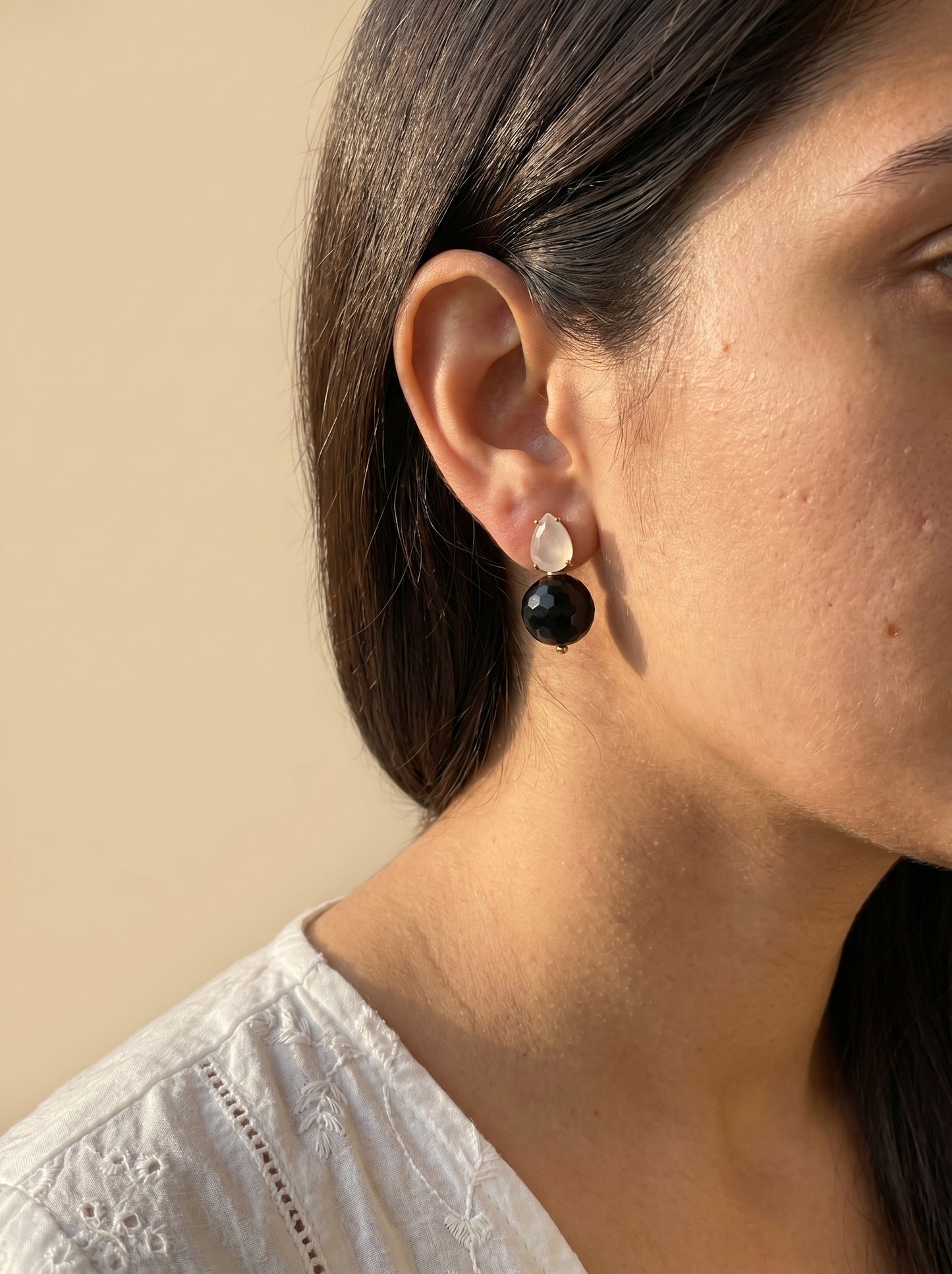 
Model wearing black rutile quartz drop earrings showing full earring detail, side profile