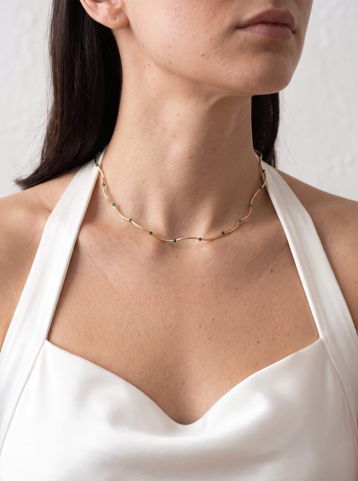 Malachite Bead Chain Necklace gold-plated worn on model with white halter top, close-up at neckline — StoneCraft Jewellery