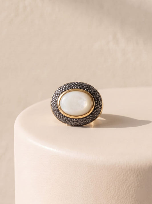 Front view of StoneCraft Jewellery mother-of-pearl ring with gold plating and textured black rhodium detail.