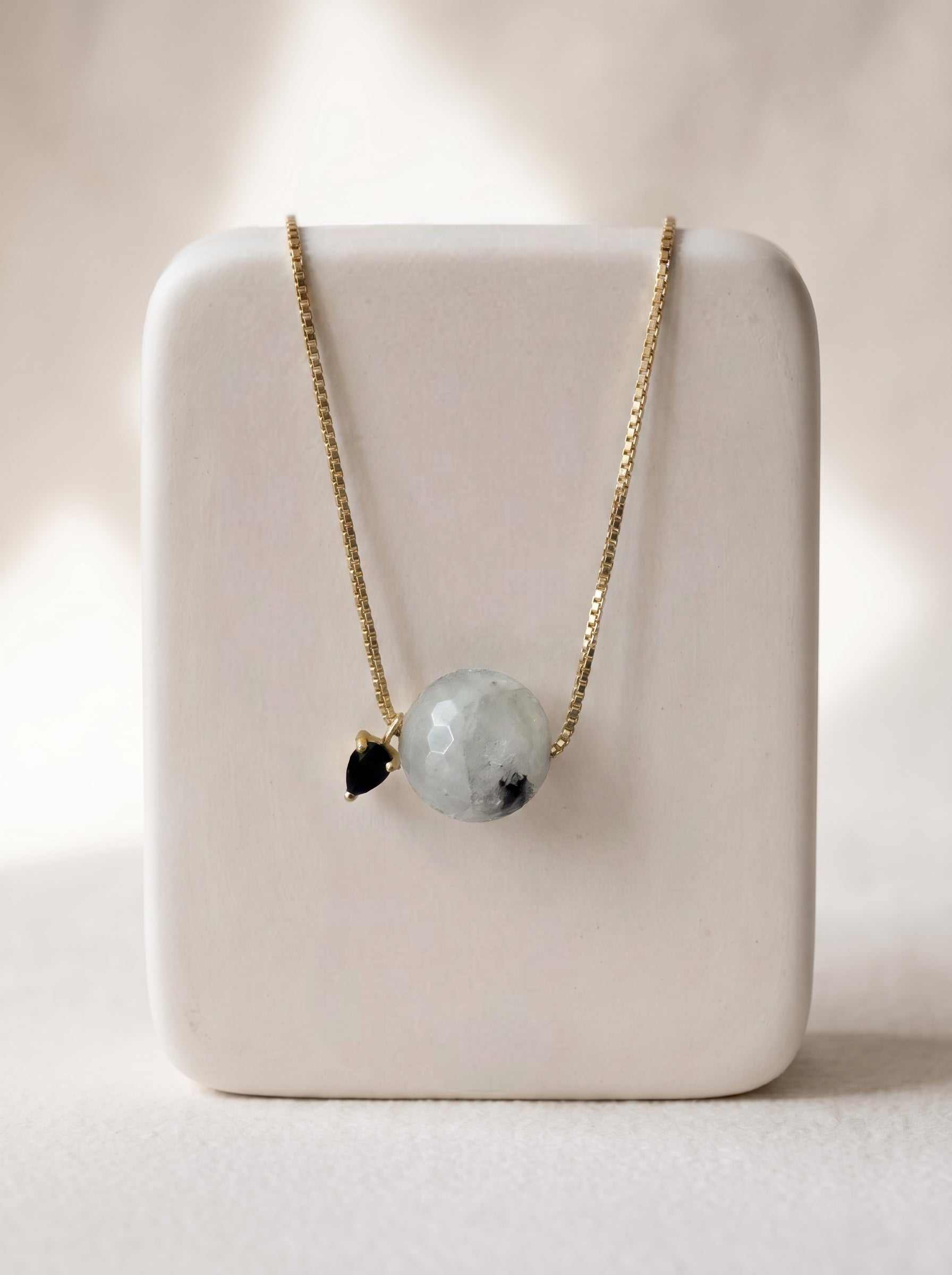 StoneCraft Jewellery - Black rutile quartz slide necklace on a white ceramic jewellery stand