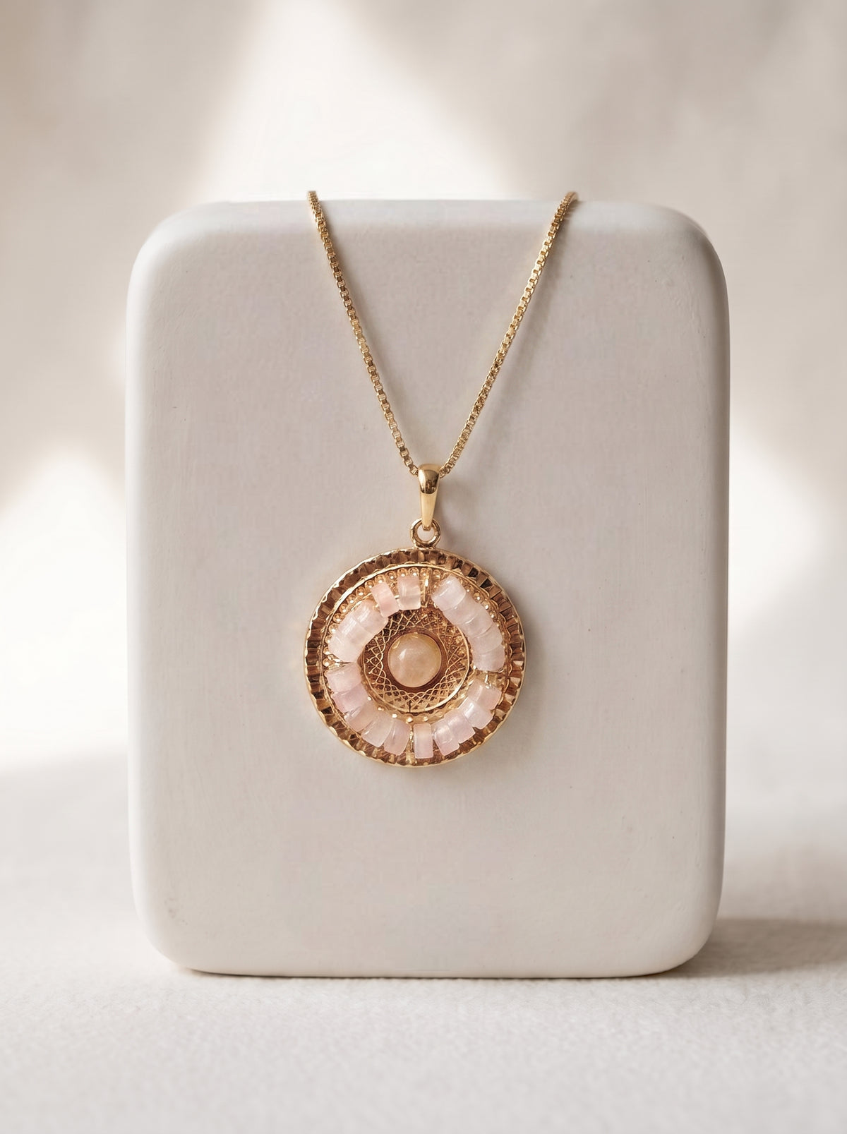 Rose Quartz Mandala gold-plated pendant necklace on white jewellery stand — StoneCraft Jewellery