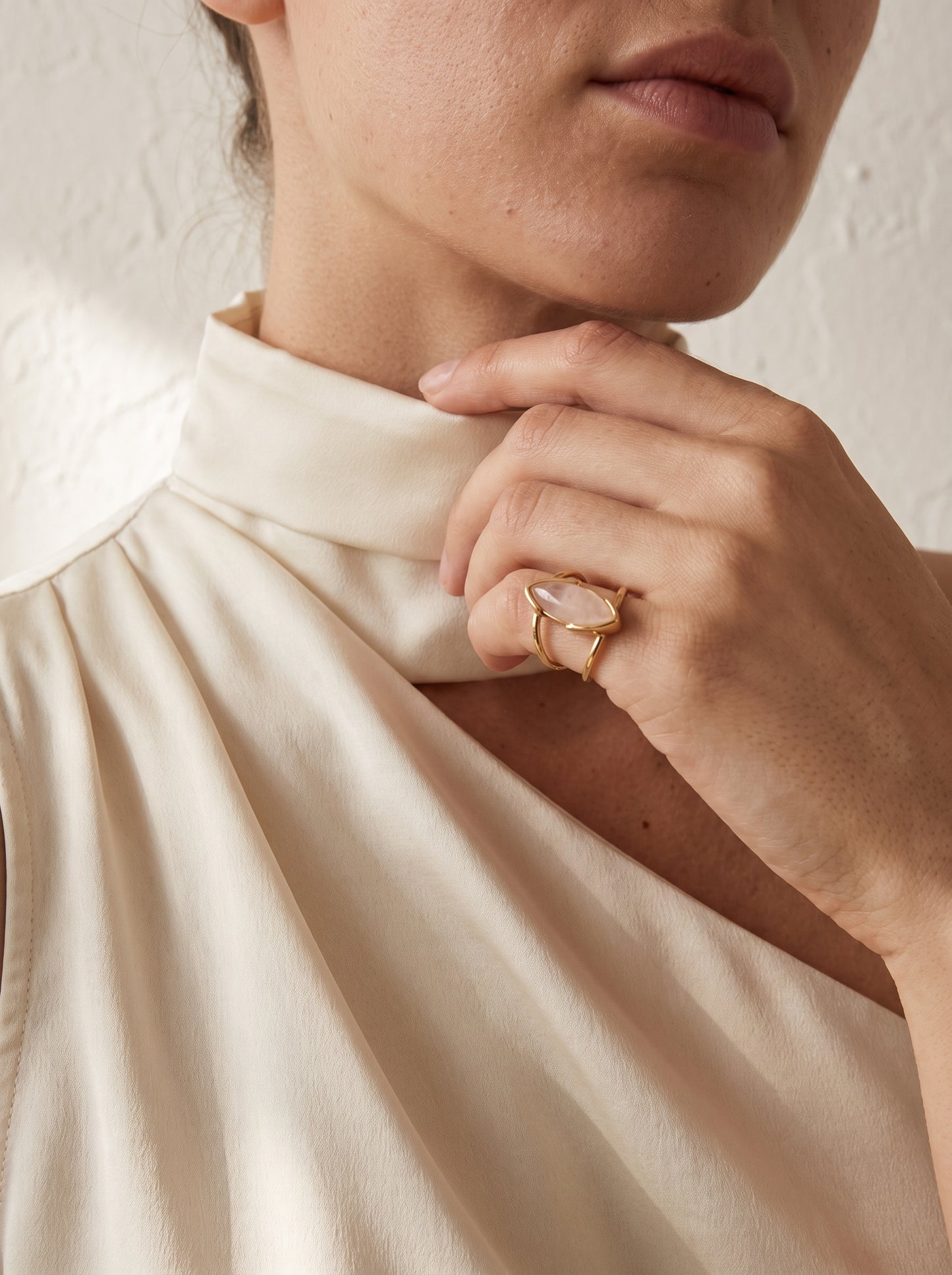 Woman wearing StoneCraft Jewellery rose quartz marquise cuff ring gold plated close up on hand