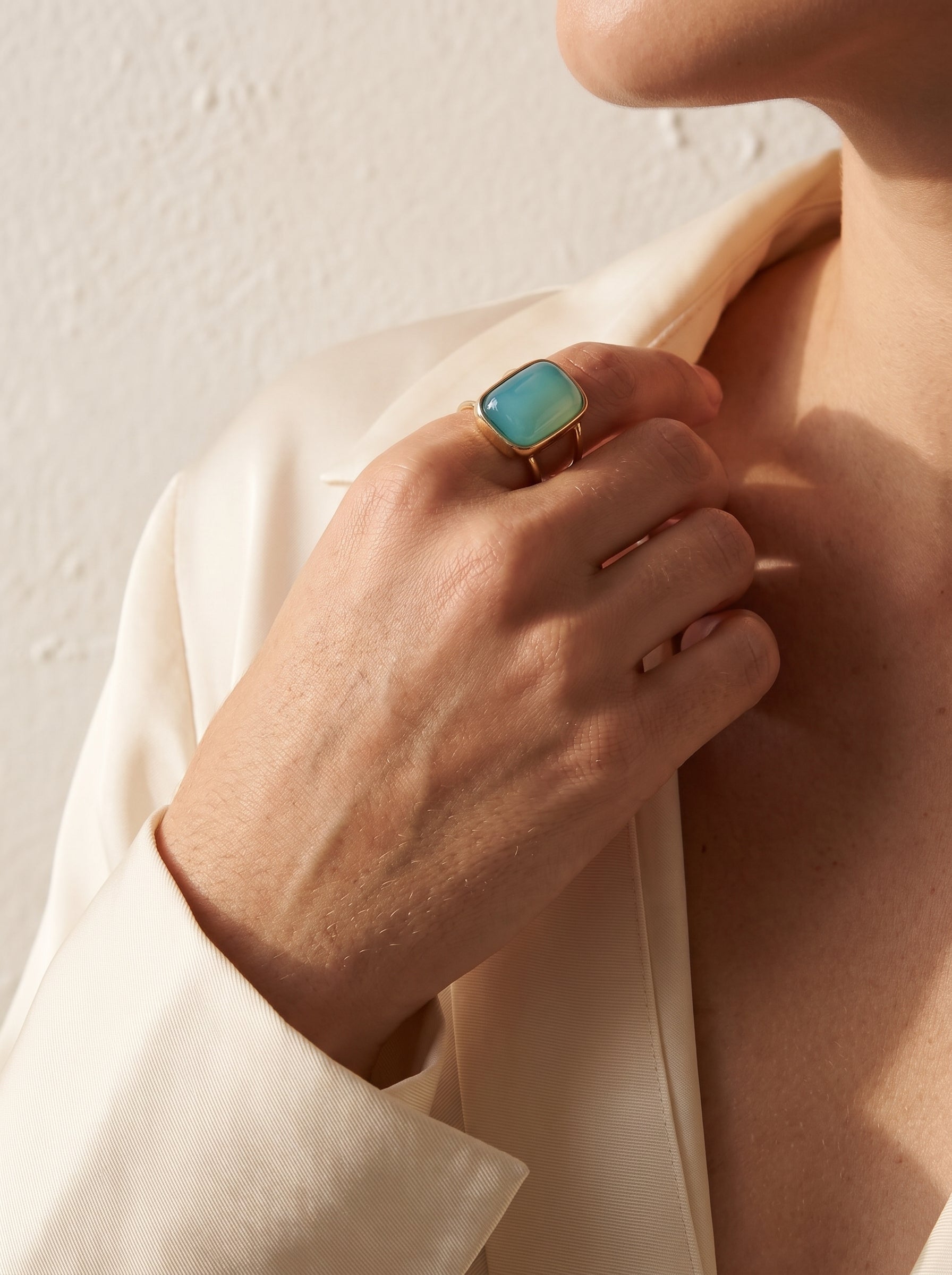 Woman wearing StoneCraft Jewellery aqua agate cushion cuff ring gold plated on hand