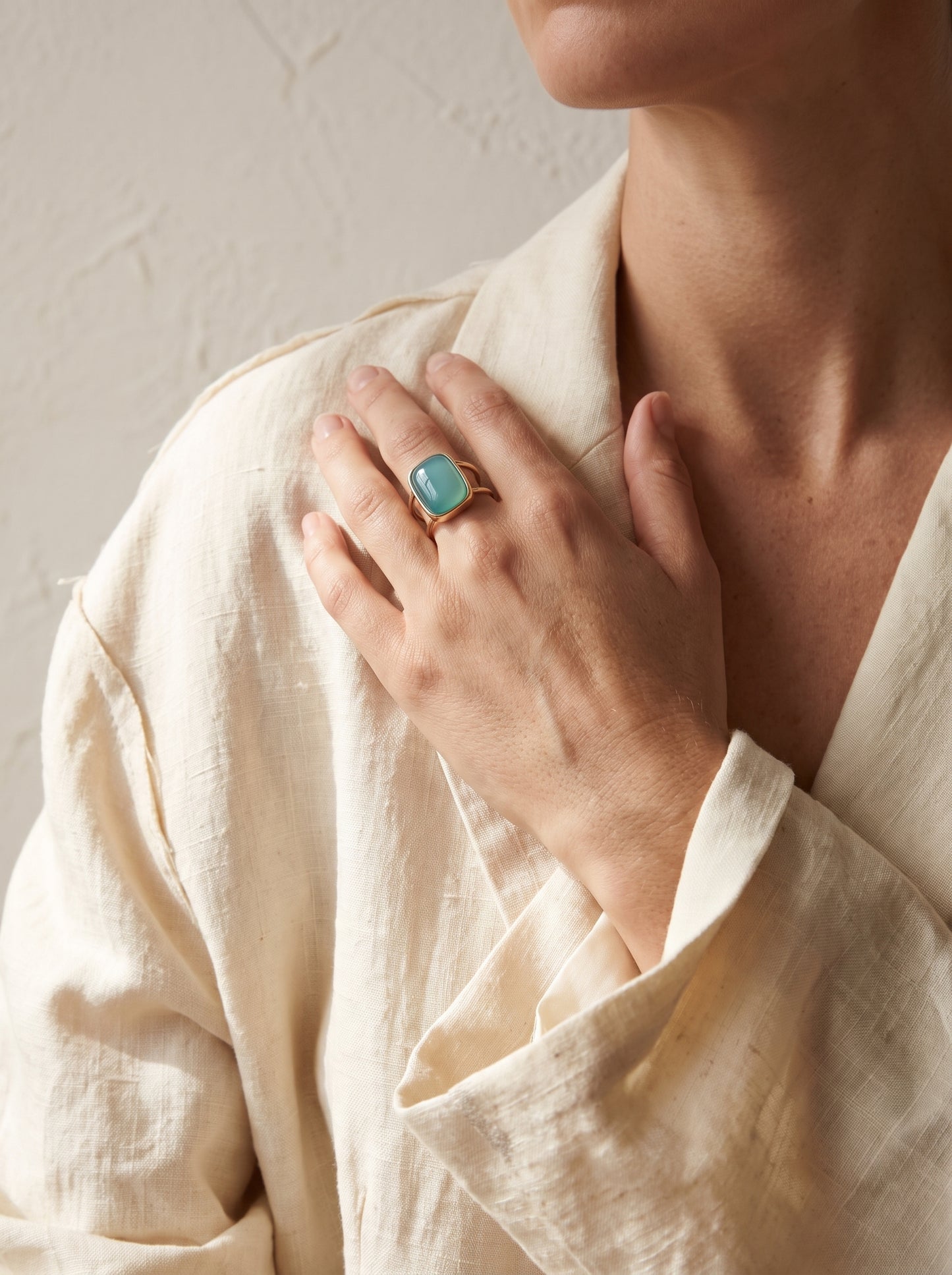 Woman wearing StoneCraft Jewellery aqua agate cushion cuff ring gold plated close up