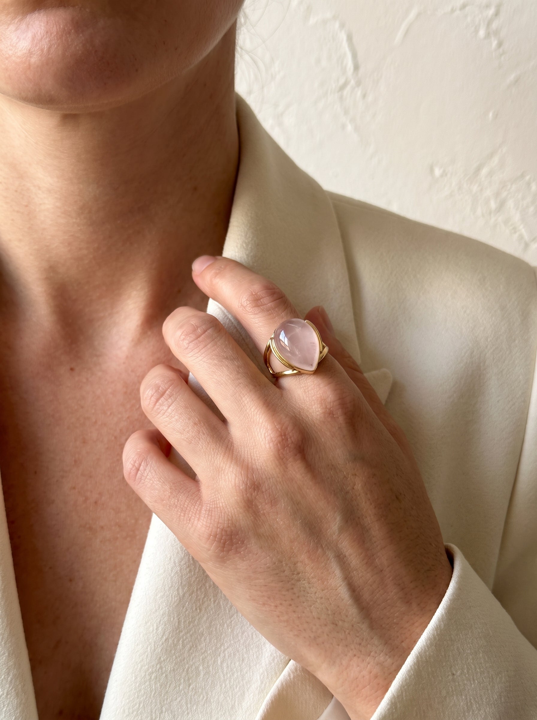 Woman wearing StoneCraft Jewellery rose quartz teardrop gold plated ring on hand