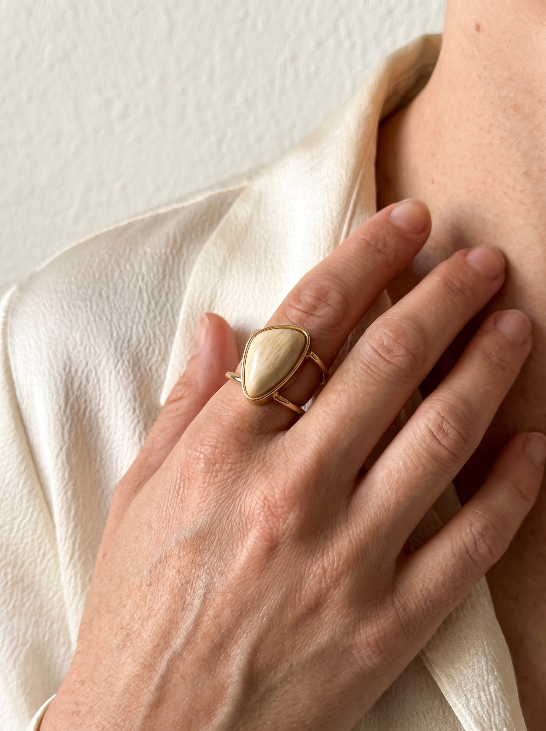Model wearing beige amazonite asymmetric gold-plated cuff ring, styled with white blazer – StoneCraft Jewellery
