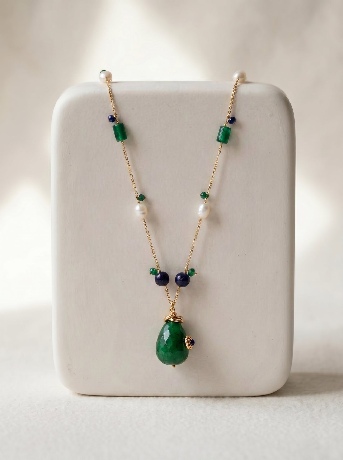 close-up of green jade and pearl long necklace showing bead detail on gold-plated chain