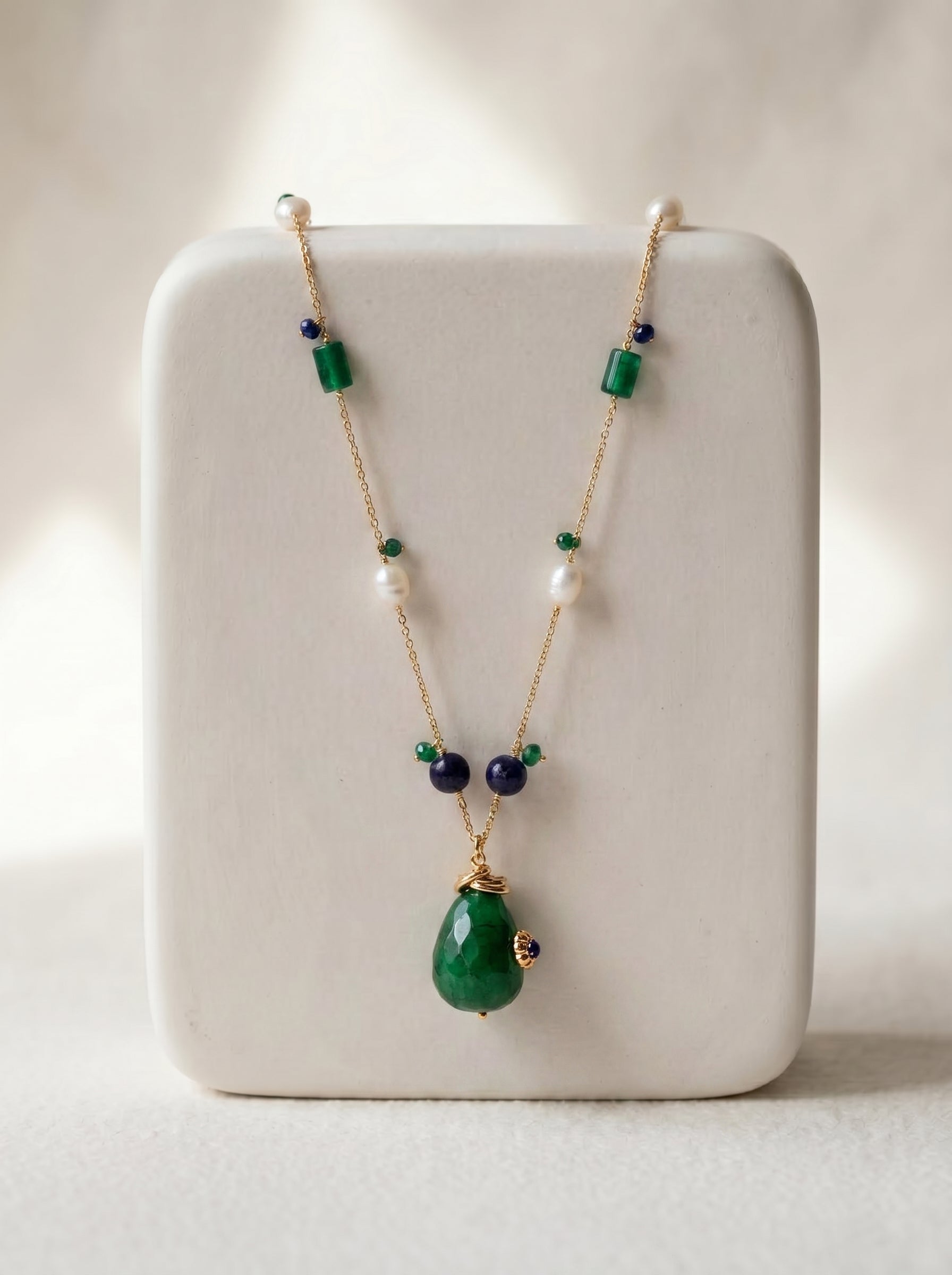 close-up of green jade and pearl long necklace showing bead detail on gold-plated chain