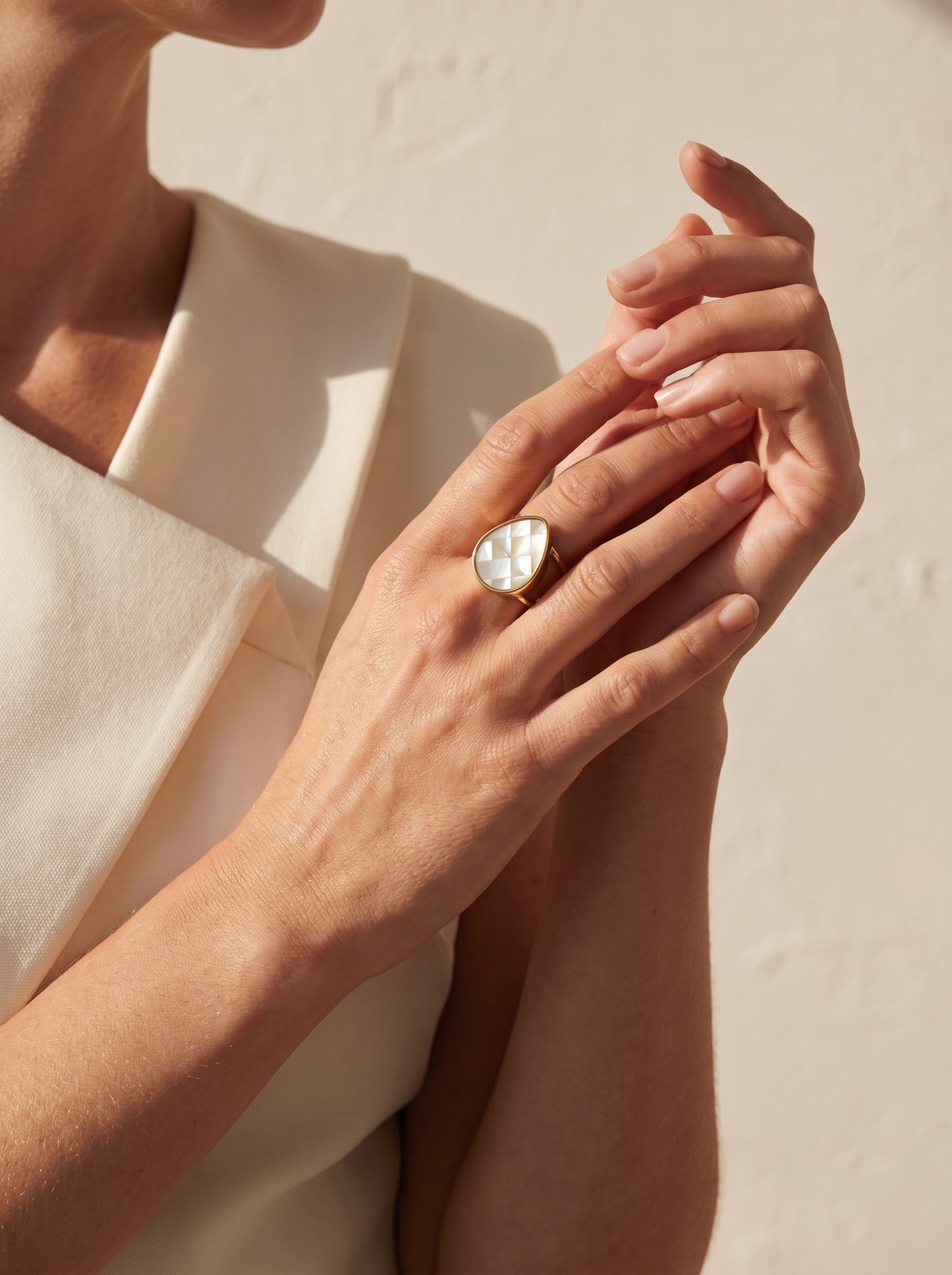 Mother-of-Pearl Teardrop Adjustable Ring worn on model's hand against cream background — StoneCraft Jewellery