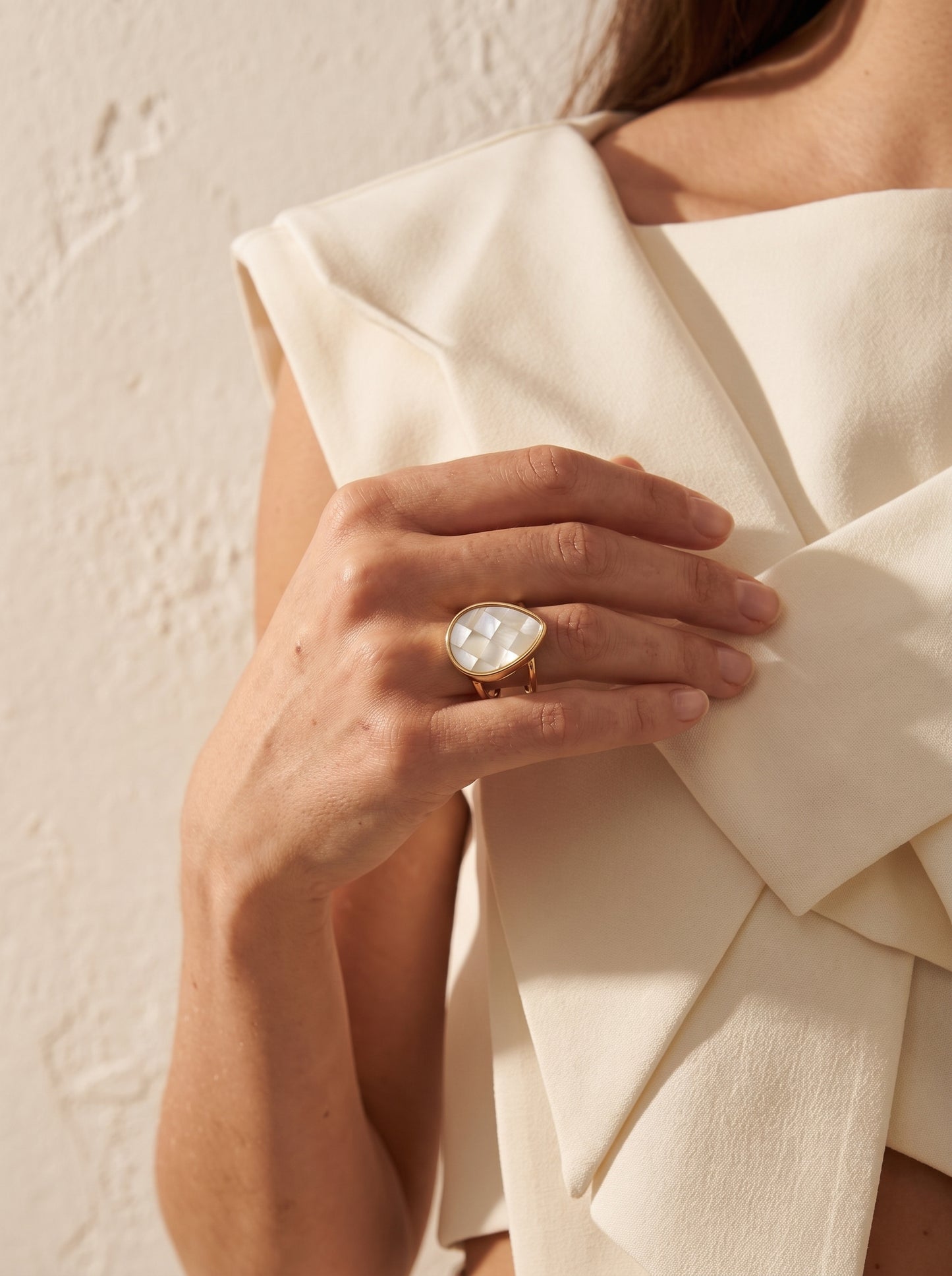 Mother-of-Pearl Teardrop Adjustable Ring worn on model's hand resting on white fabric — StoneCraft Jewellery