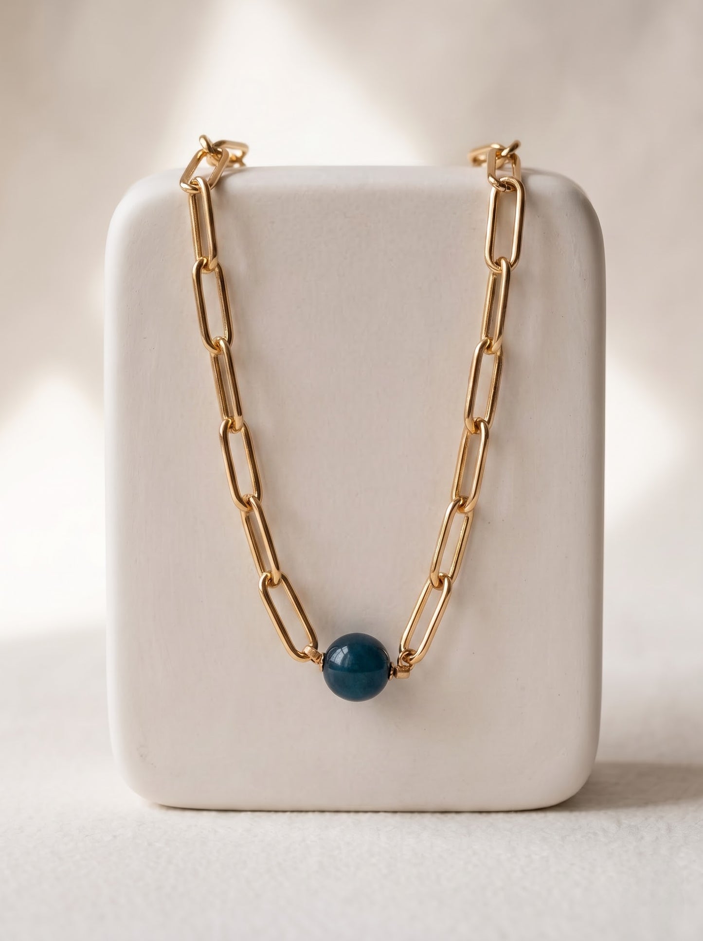 StoneCraft Jewellery apatite gemstone sphere gold paperclip chain necklace, displayed on white ceramic jewellery stand.