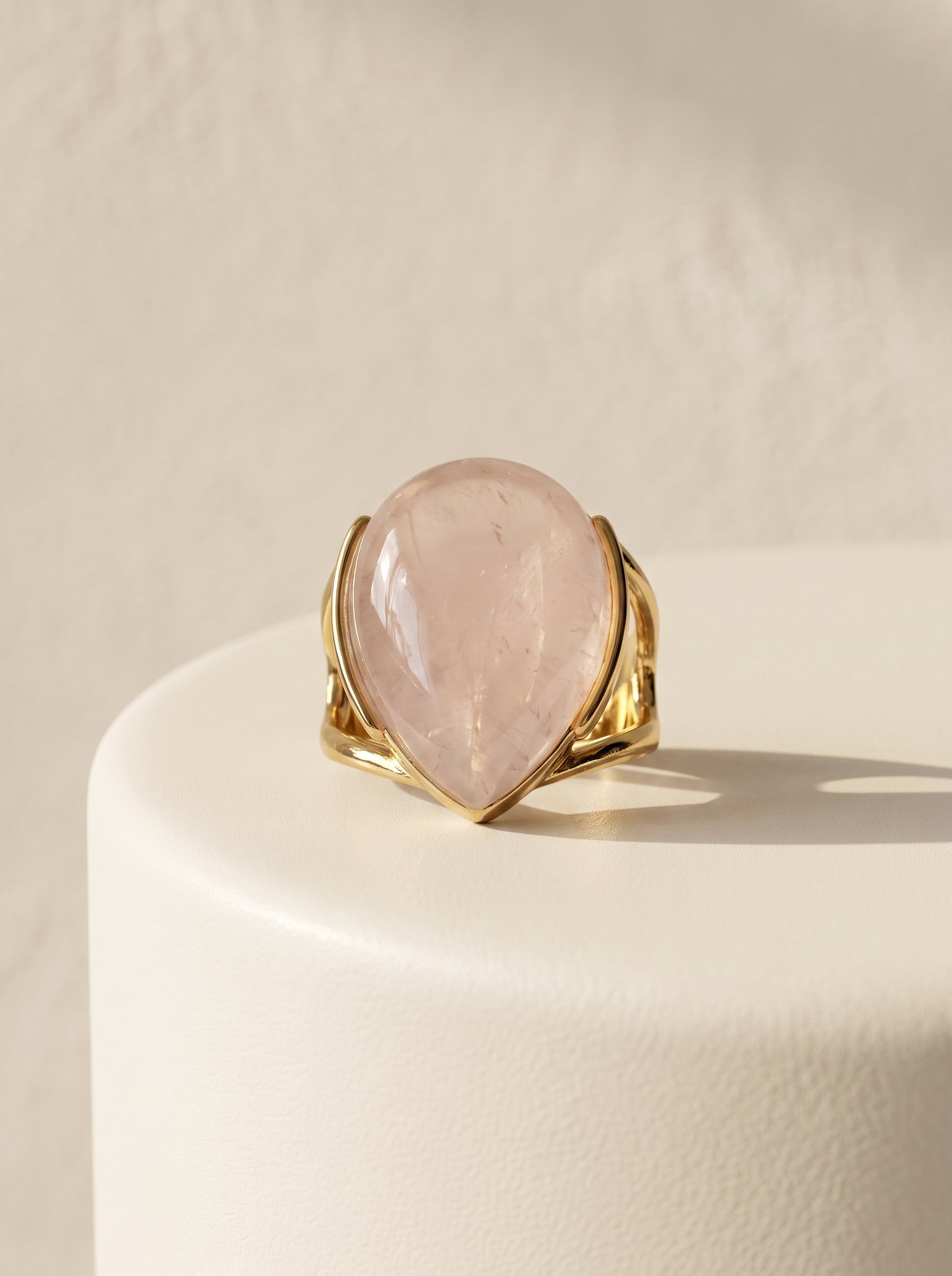 StoneCraft Jewellery rose quartz teardrop gold plated ring front view on white surface