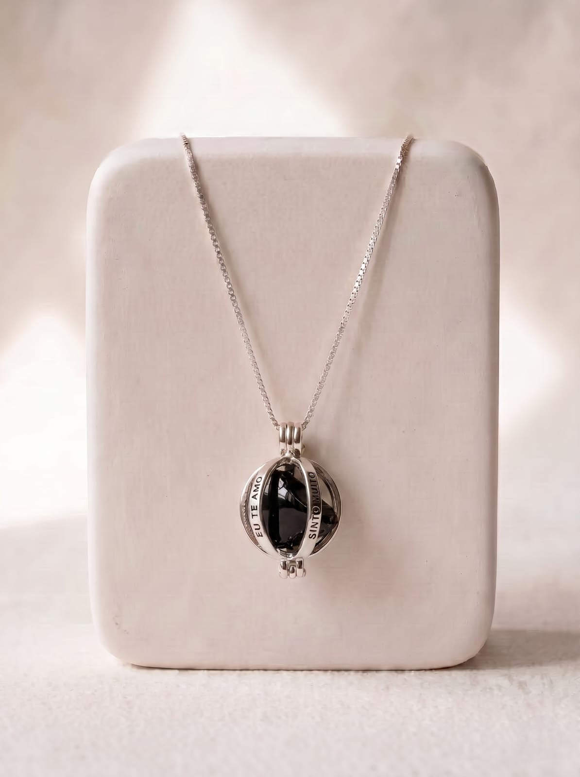StoneCraft Jewellery Angel Caller Necklace Rhodium Plated with Black Agate displayed on white jewellery stand