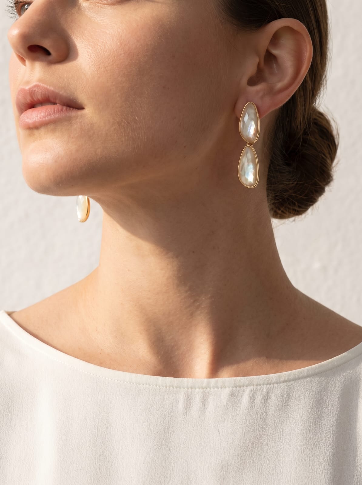 Model wearing nautilus shell dangle earrings in gold-plated finish, styled for everyday wear – StoneCraft Jewellery
