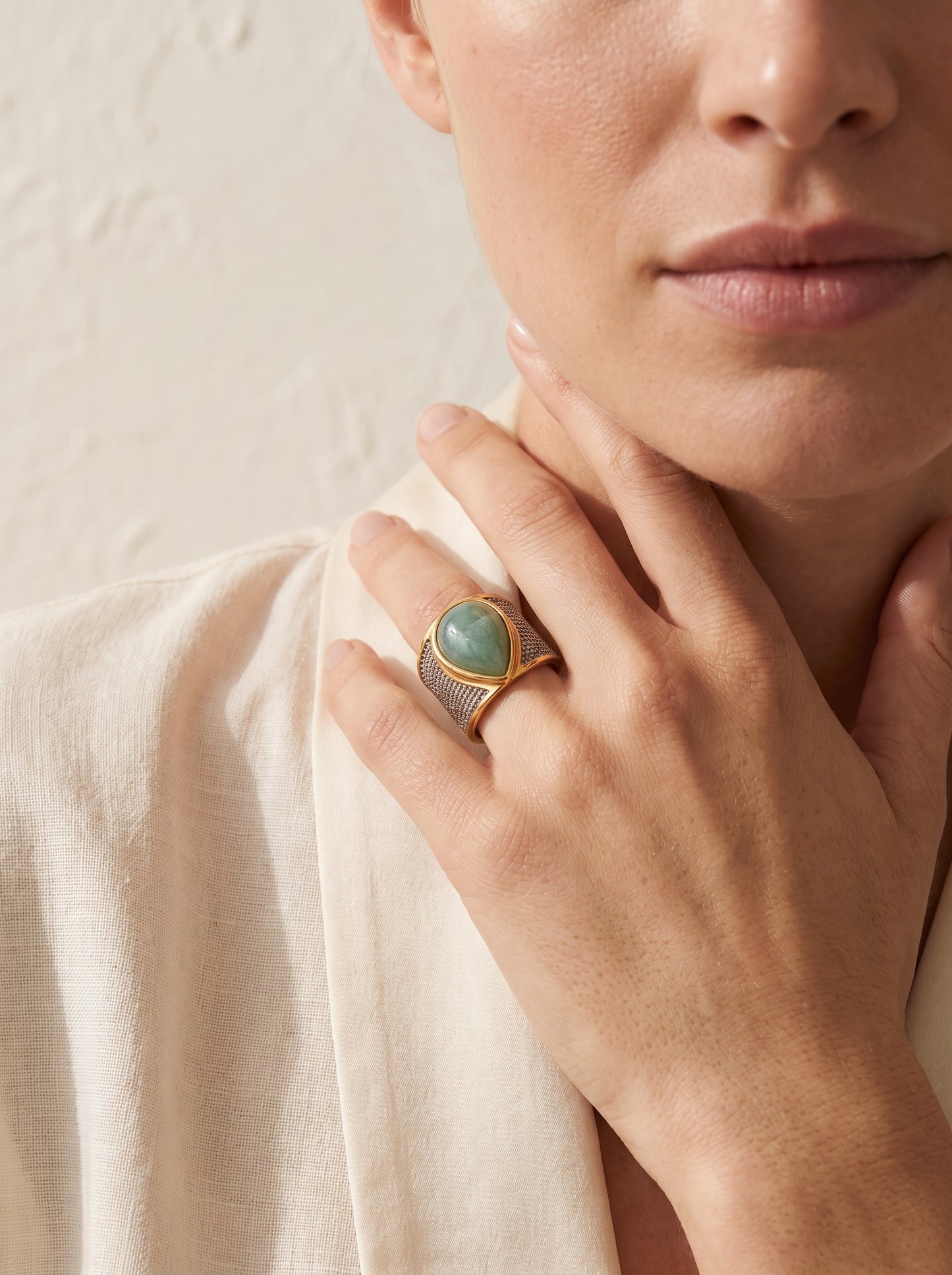 Woman wearing StoneCraft Jewellery green quartz teardrop wide band ring gold white rhodium plated on hand