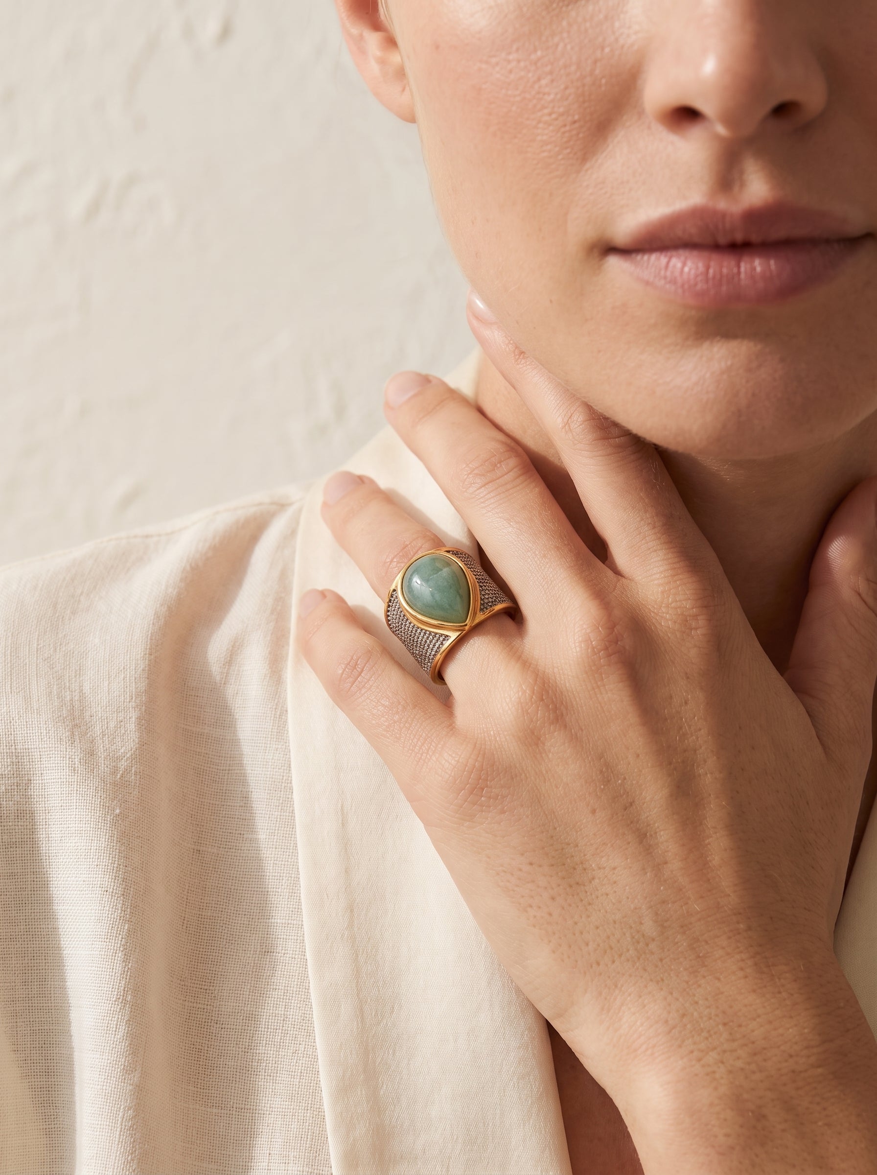 Woman wearing StoneCraft Jewellery green quartz teardrop wide band ring gold white rhodium plated on hand