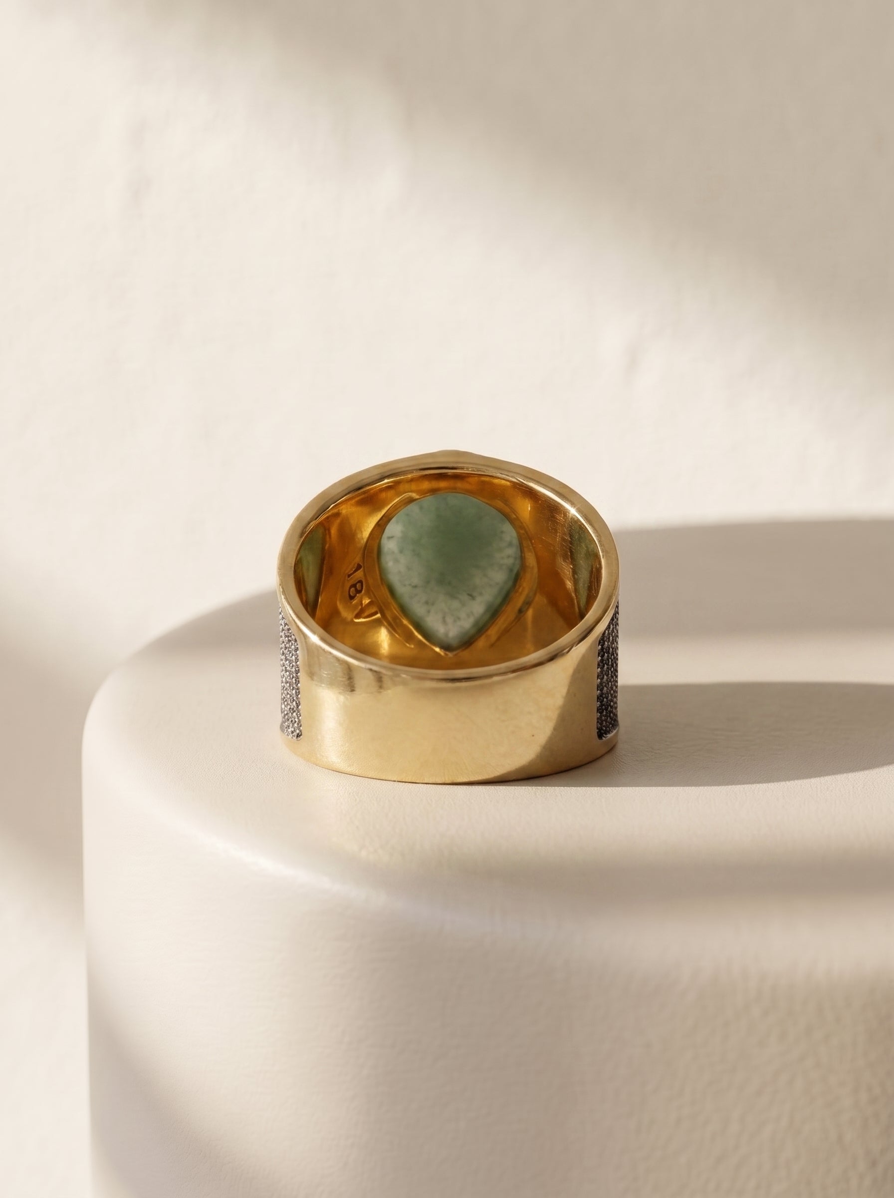 StoneCraft Jewellery green quartz teardrop wide band ring gold white rhodium plated back view on white surface