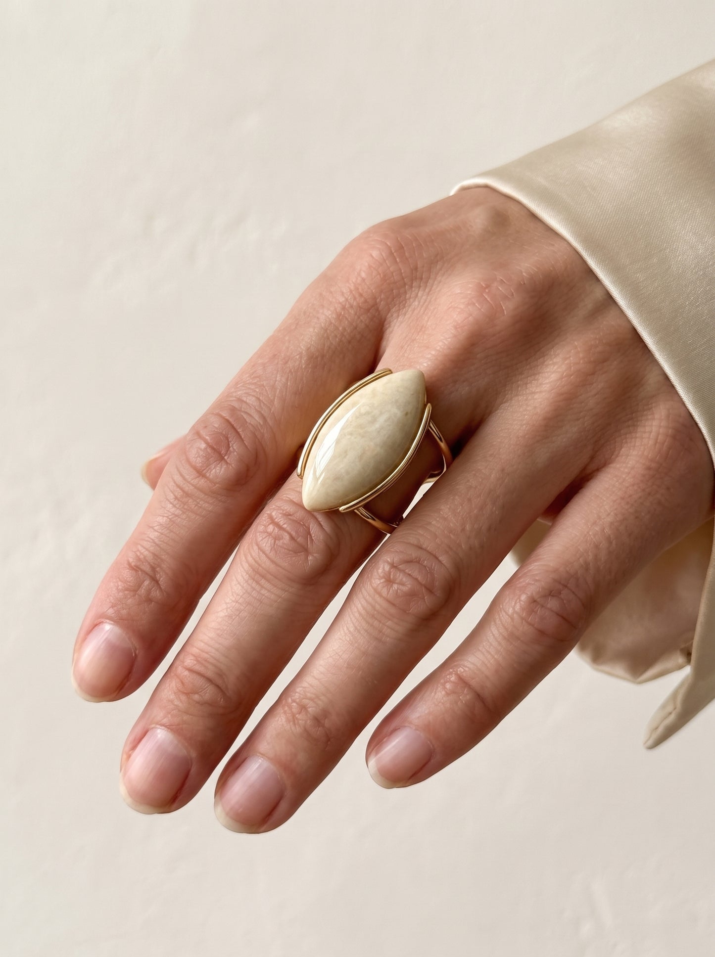 Close-up of beige amazonite marquise gold ring worn on hand, showing natural stone detail – StoneCraft Jewellery