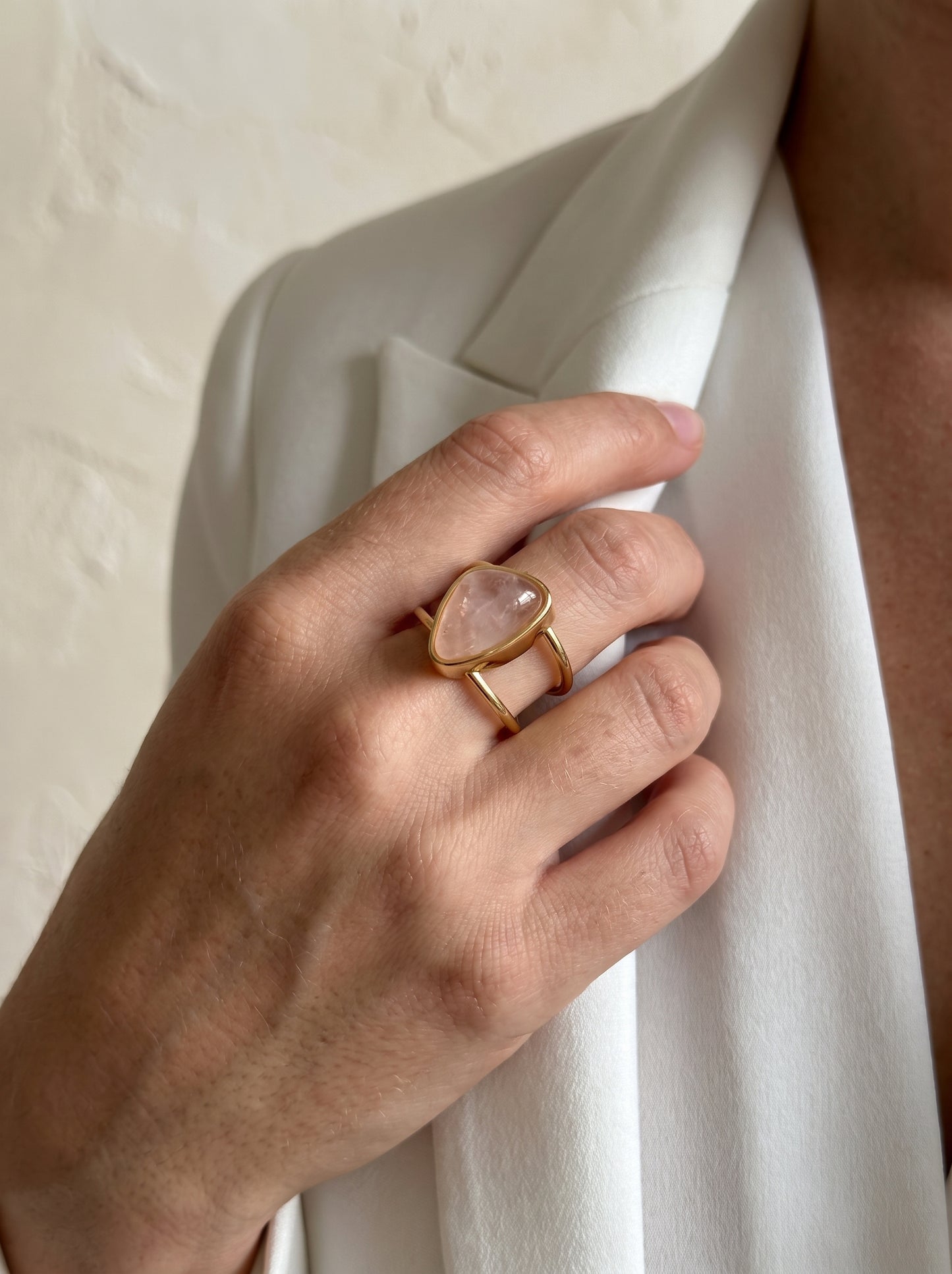 Model wearing rose quartz asymmetric gold-plated cuff ring, side view – StoneCraft Jewellery