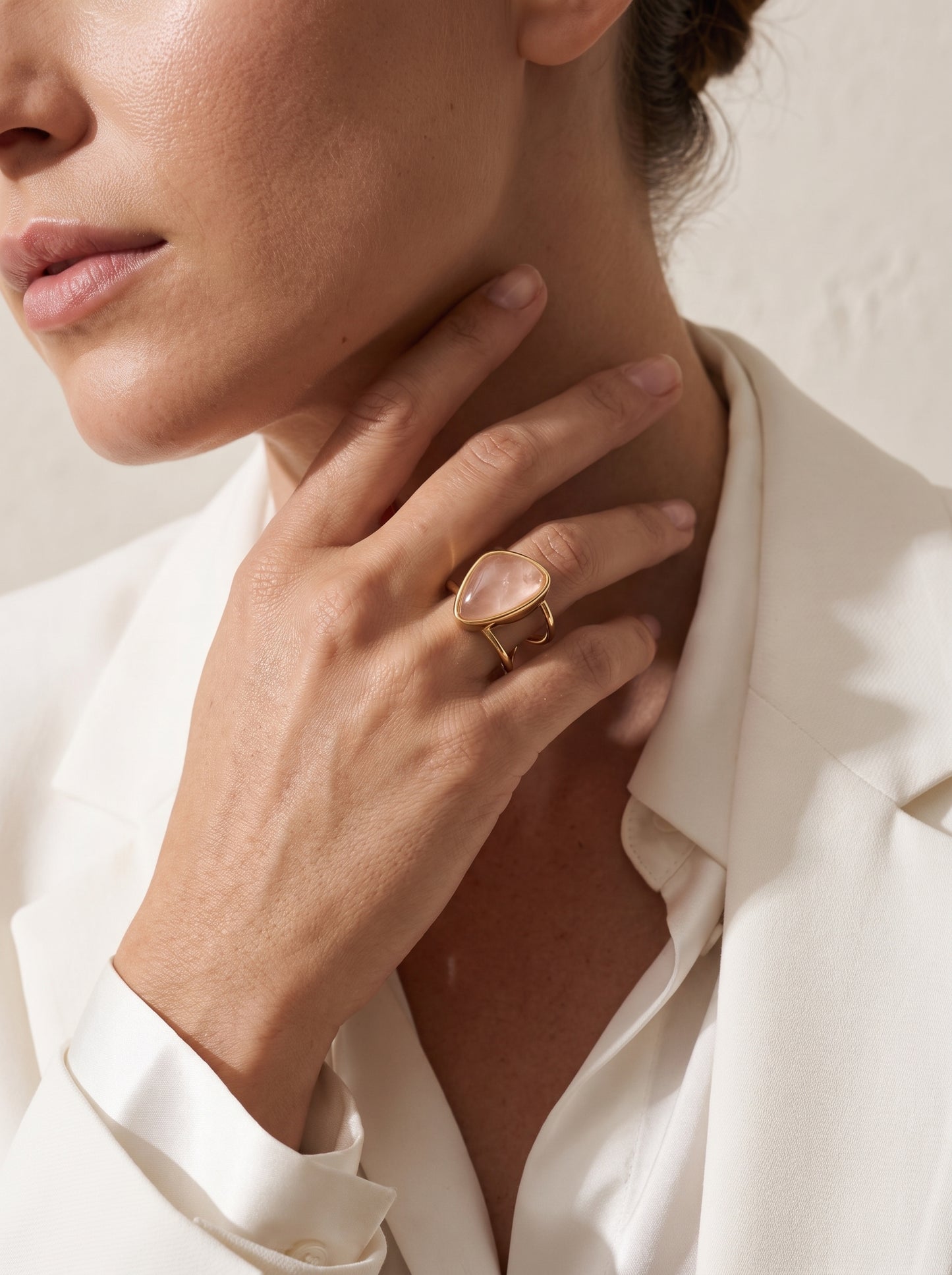 Rose quartz asymmetric cuff ring worn with white blazer, editorial styling – StoneCraft Jewellery
