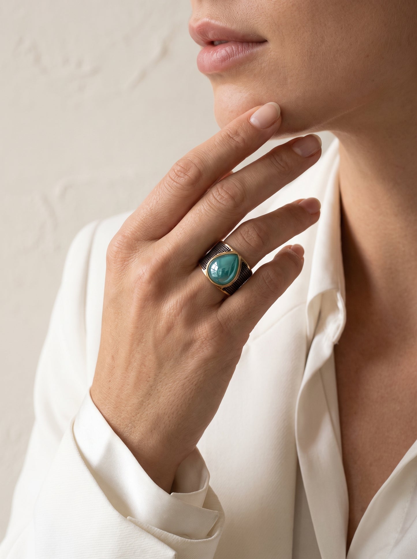 Woman wearing StoneCraft Jewellery green quartz teardrop wide band ring gold rhodium plated on hand