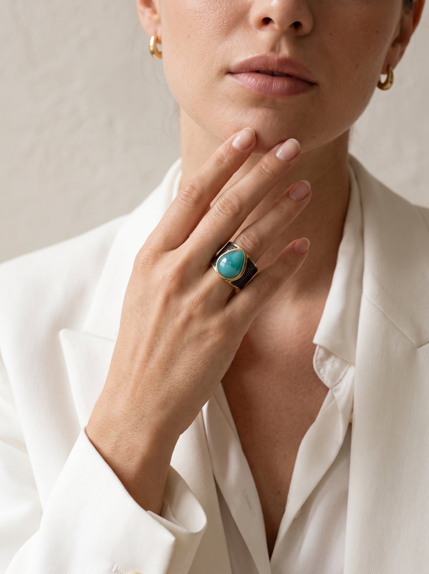 Woman wearing StoneCraft Jewellery green quartz teardrop wide band ring gold rhodium plated close up on hand