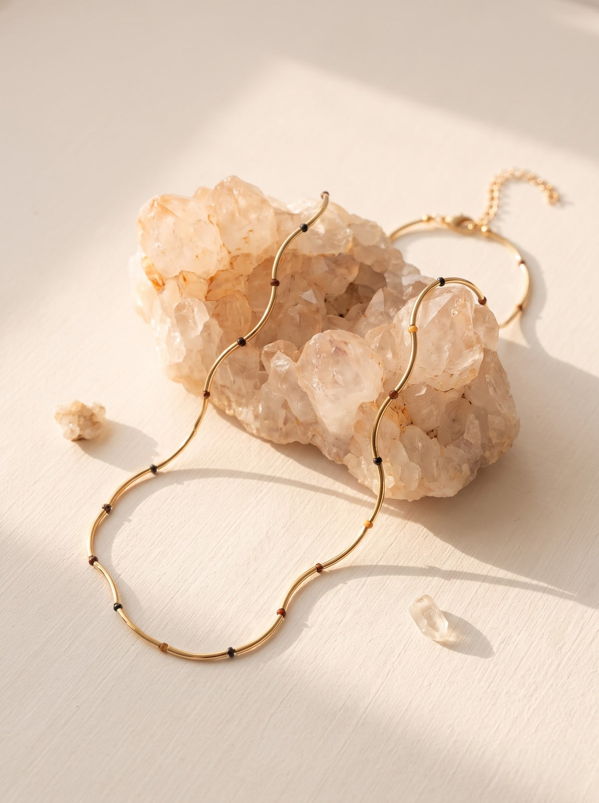 StoneCraft Jewellery Gold Wave Chain Necklace with Tiger's Eye Beads displayed on rose quartz crystal with bracelet