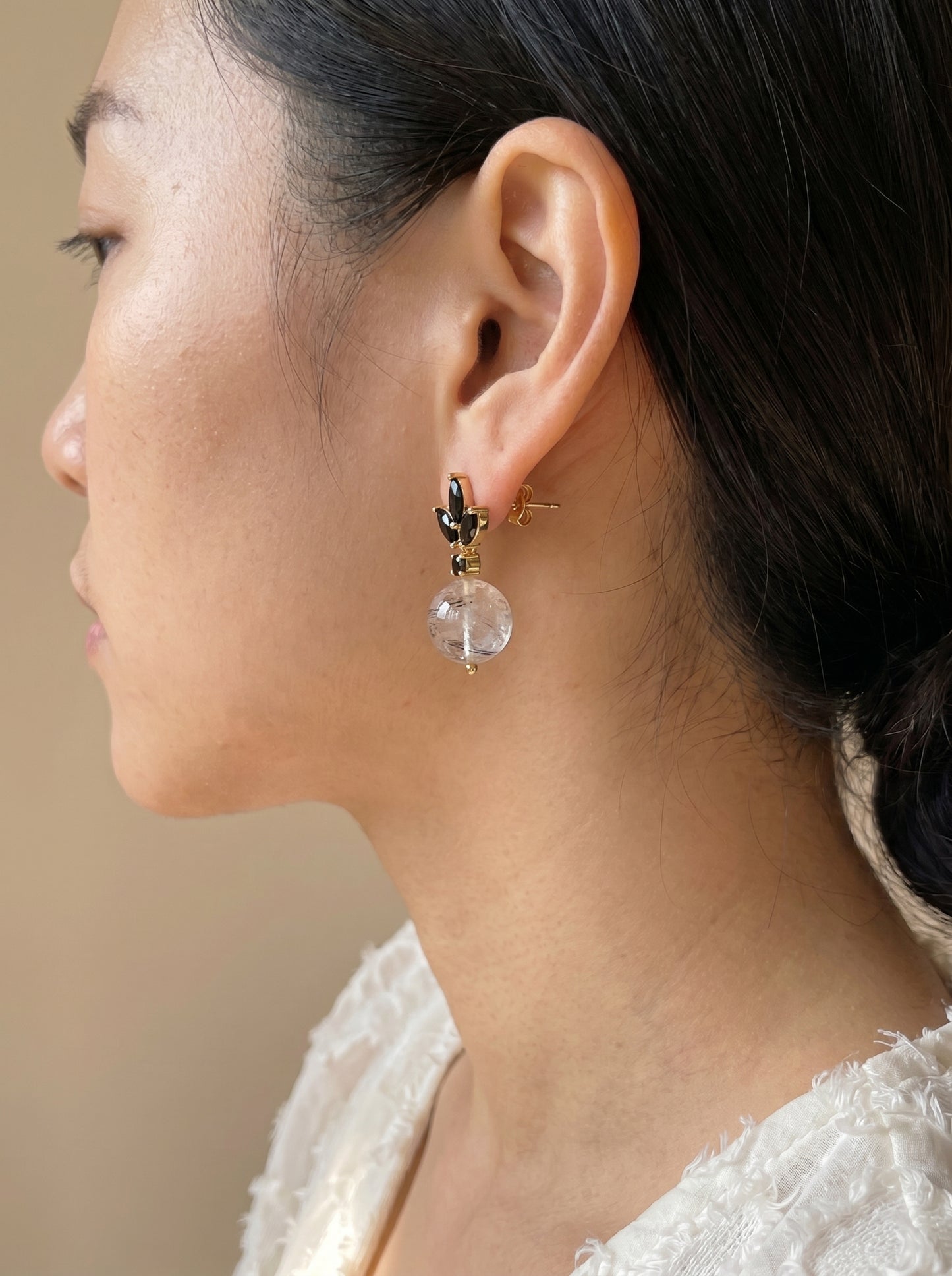 
Model wearing black rutile quartz drop earrings showing full earring detail, side profile