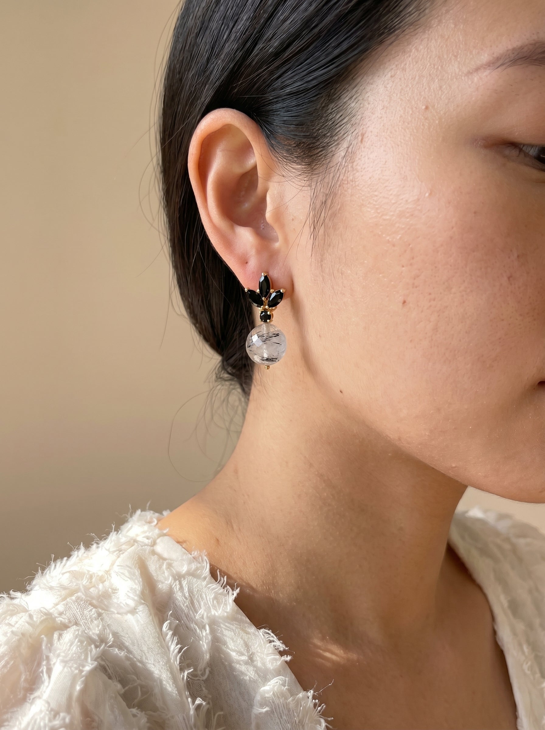 
Model wearing black rutile quartz drop earrings showing full earring detail, side profile