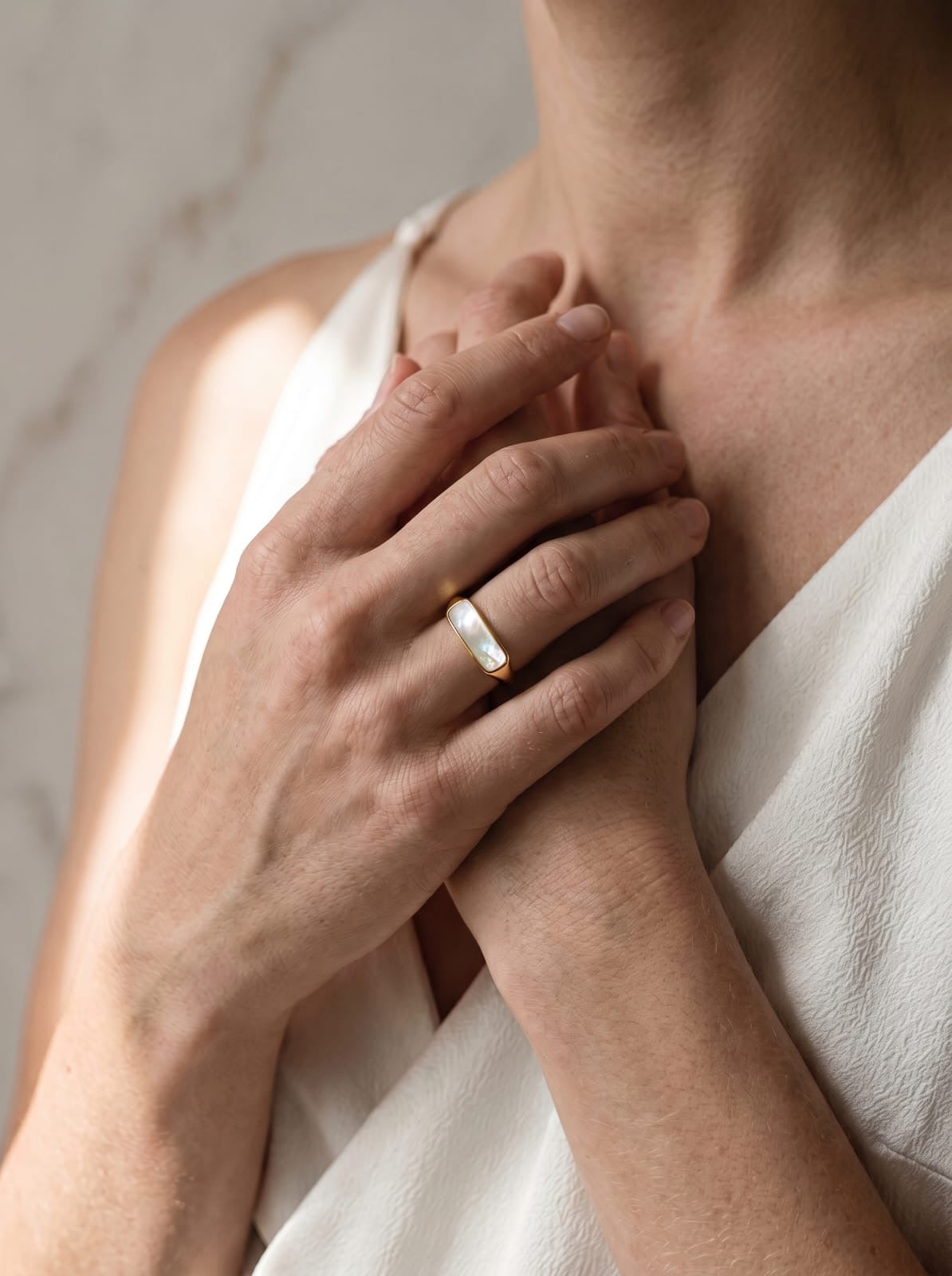 Dainty gold-plated stainless steel ring with rectangular natural shell inlay in soft white and blush pink tones