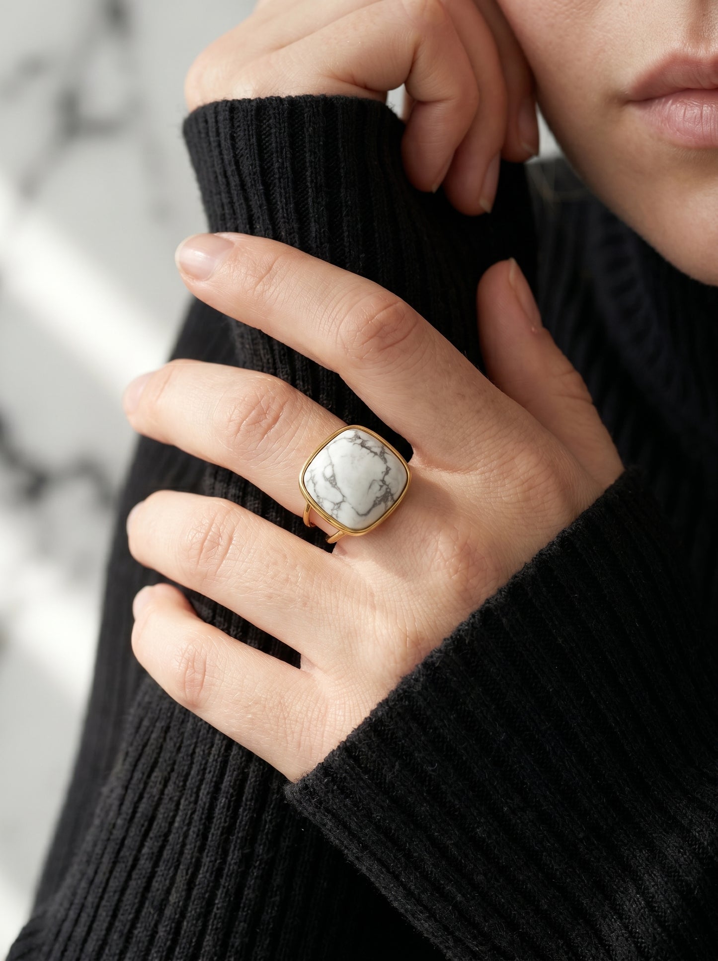 White howlite statement ring worn on hand, bold geometric gold-plated design