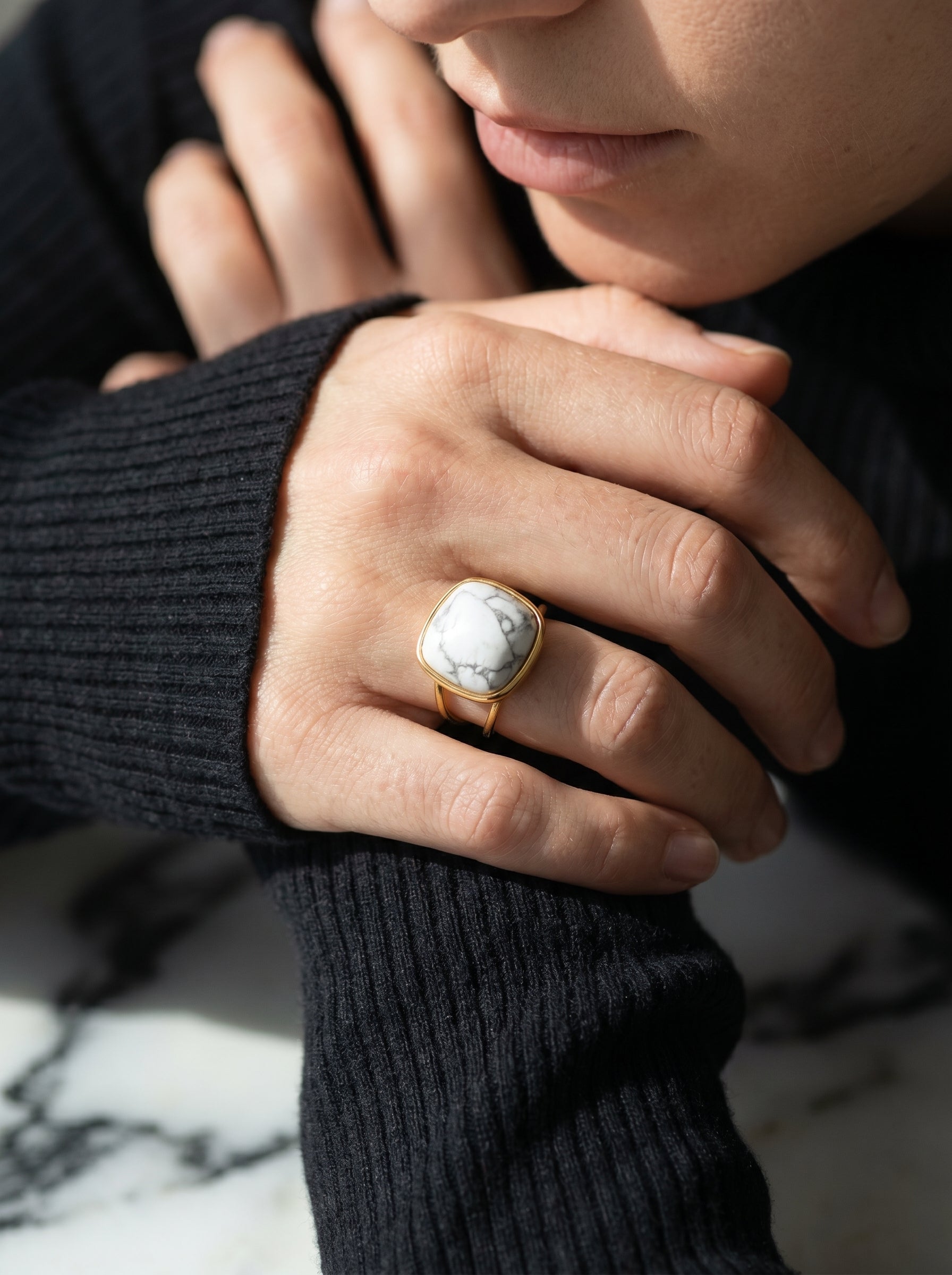 White howlite statement ring worn on hand, bold geometric gold-plated design
