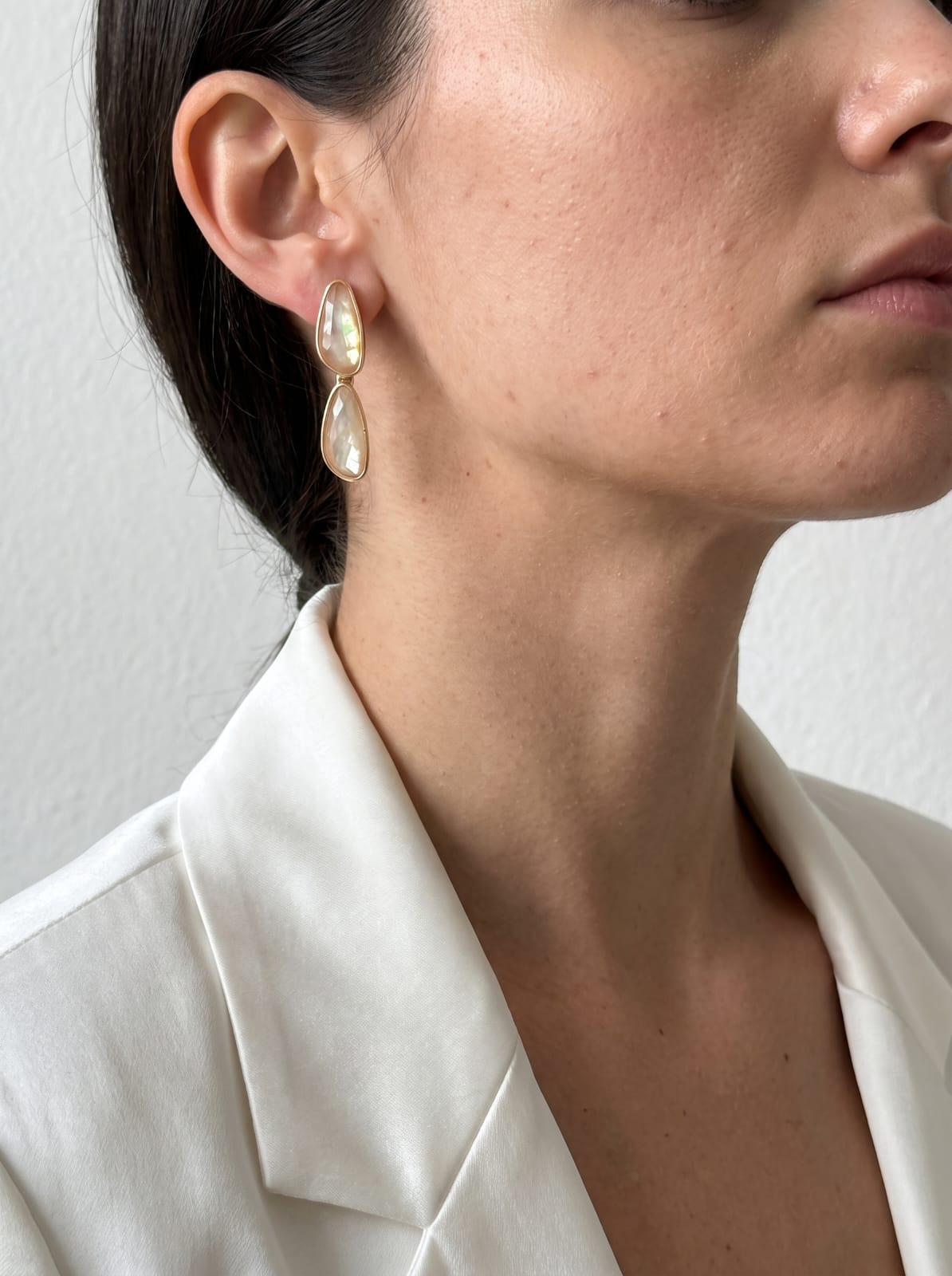Side view of model wearing nautilus shell gold-plated dangle earrings, 40mm drop – StoneCraft Jewellery