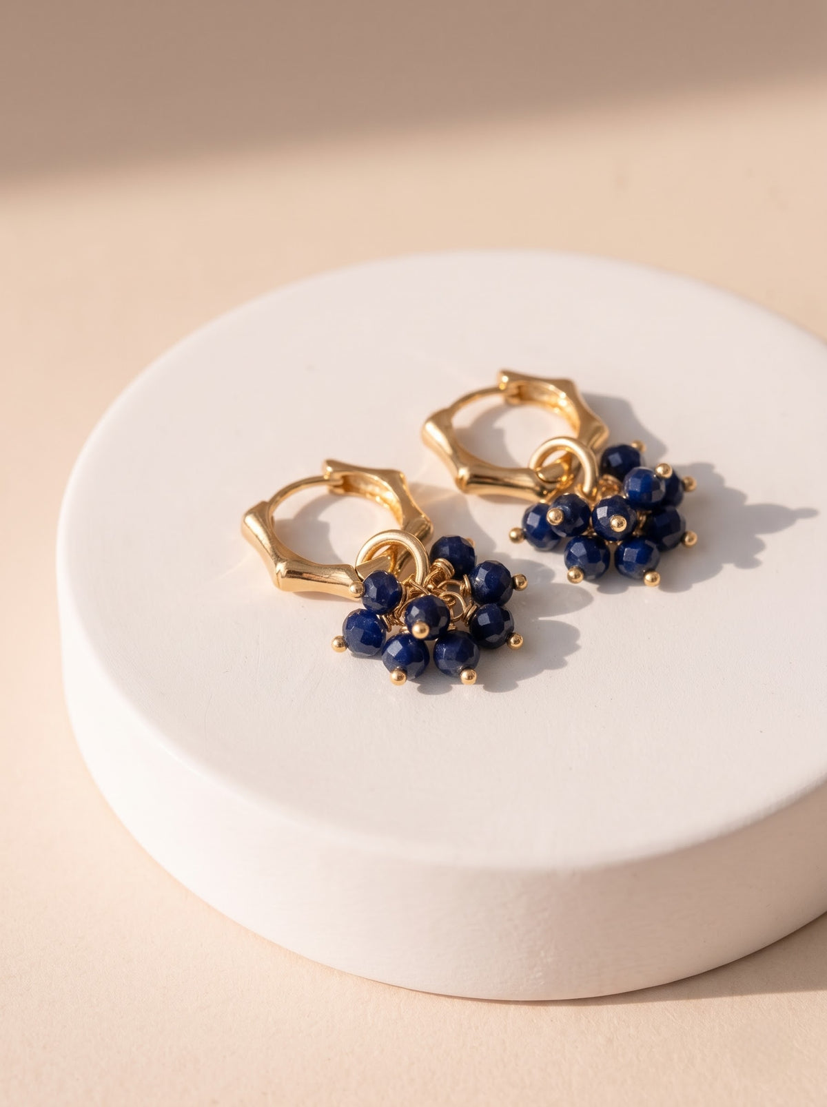 Gold-plated hoop earring with lapis lazuli bead cluster shown in close-up, StoneCraft Jewellery