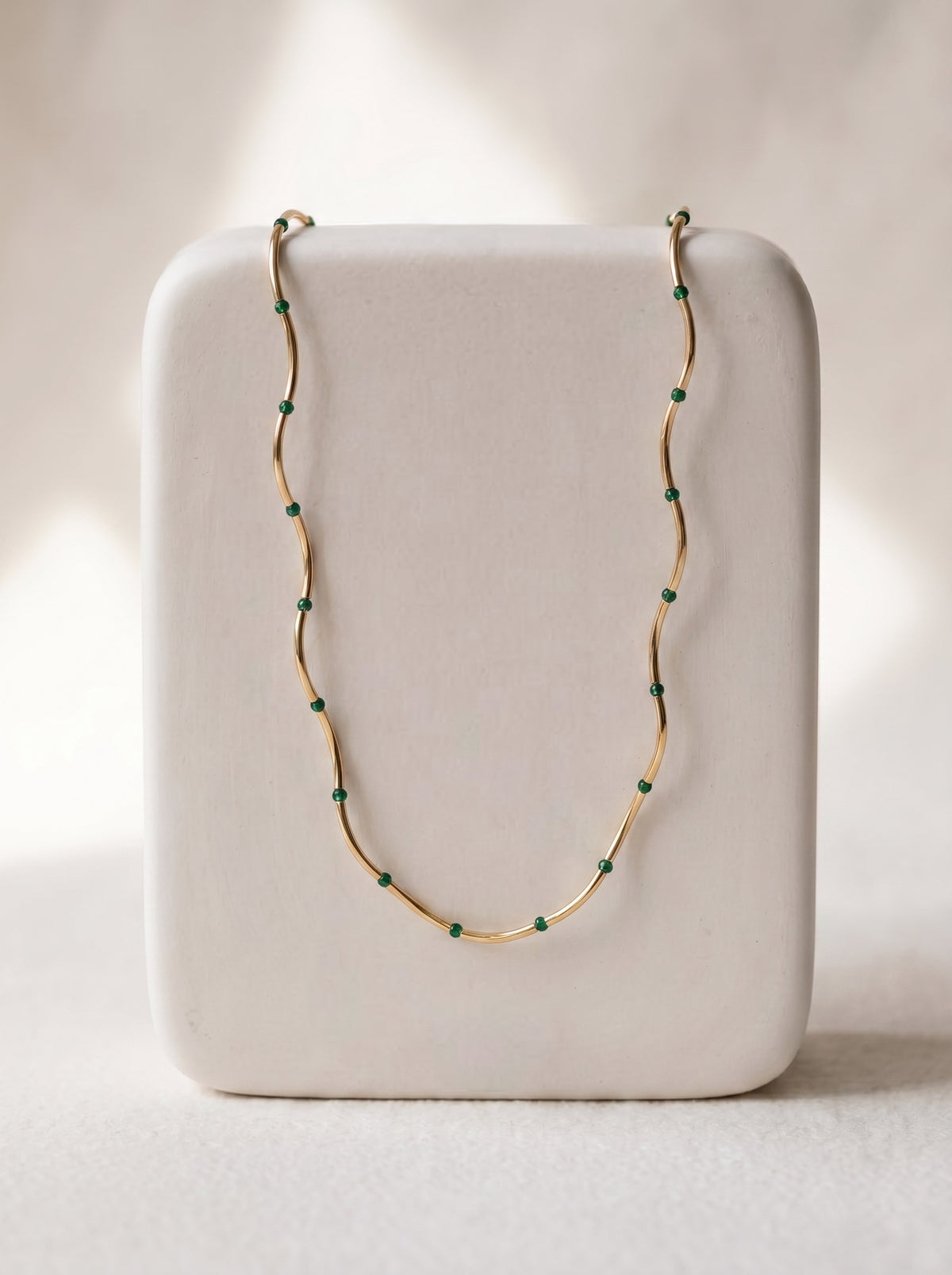 StoneCraft Jewellery Gold Wave Chain Necklace with Malachite Beads displayed on white jewellery stand