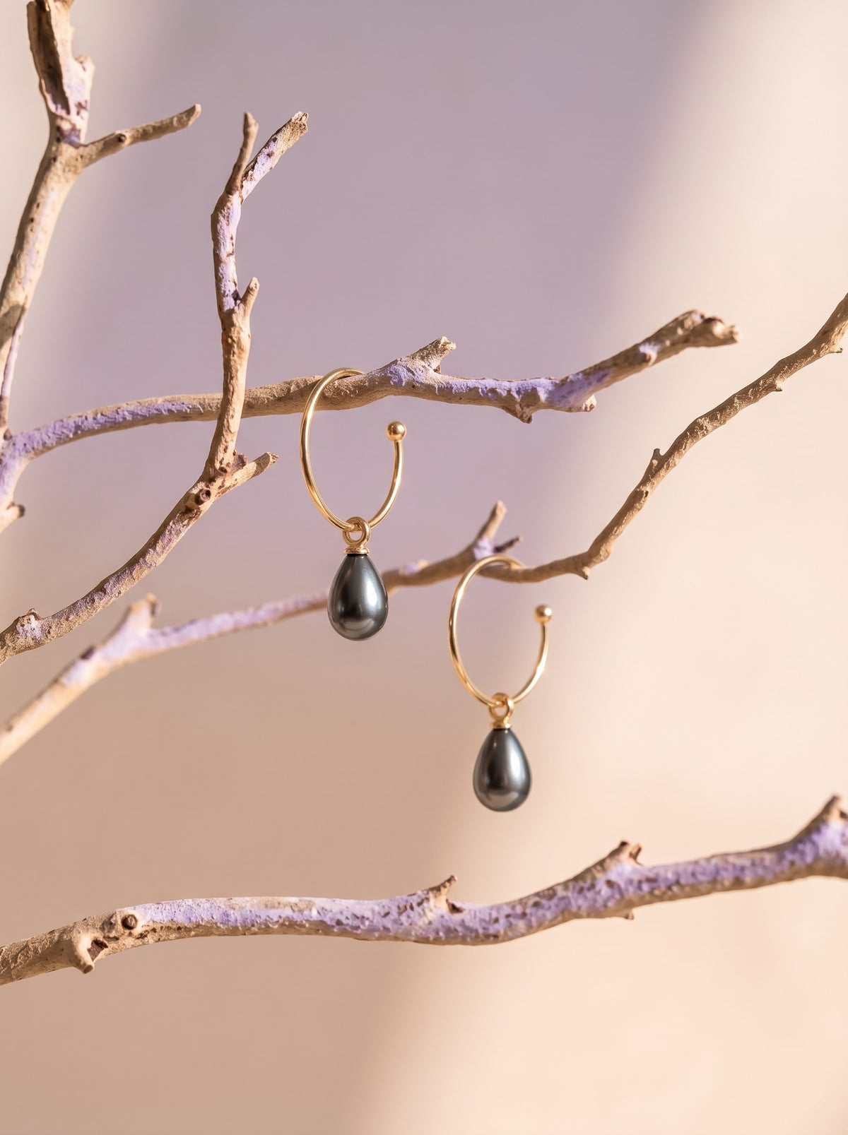 Separate branches: “StoneCraft Jewellery gold-plated open hoop earrings with grey pearl drops hanging from separate branches