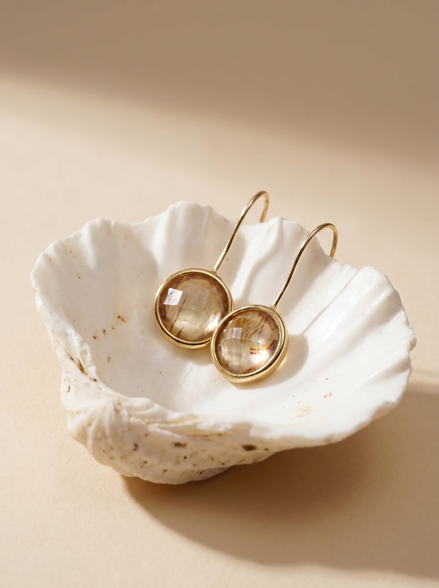 Abalone hook earrings on model, iridescent blues and greens — StoneCraft Jewellery
