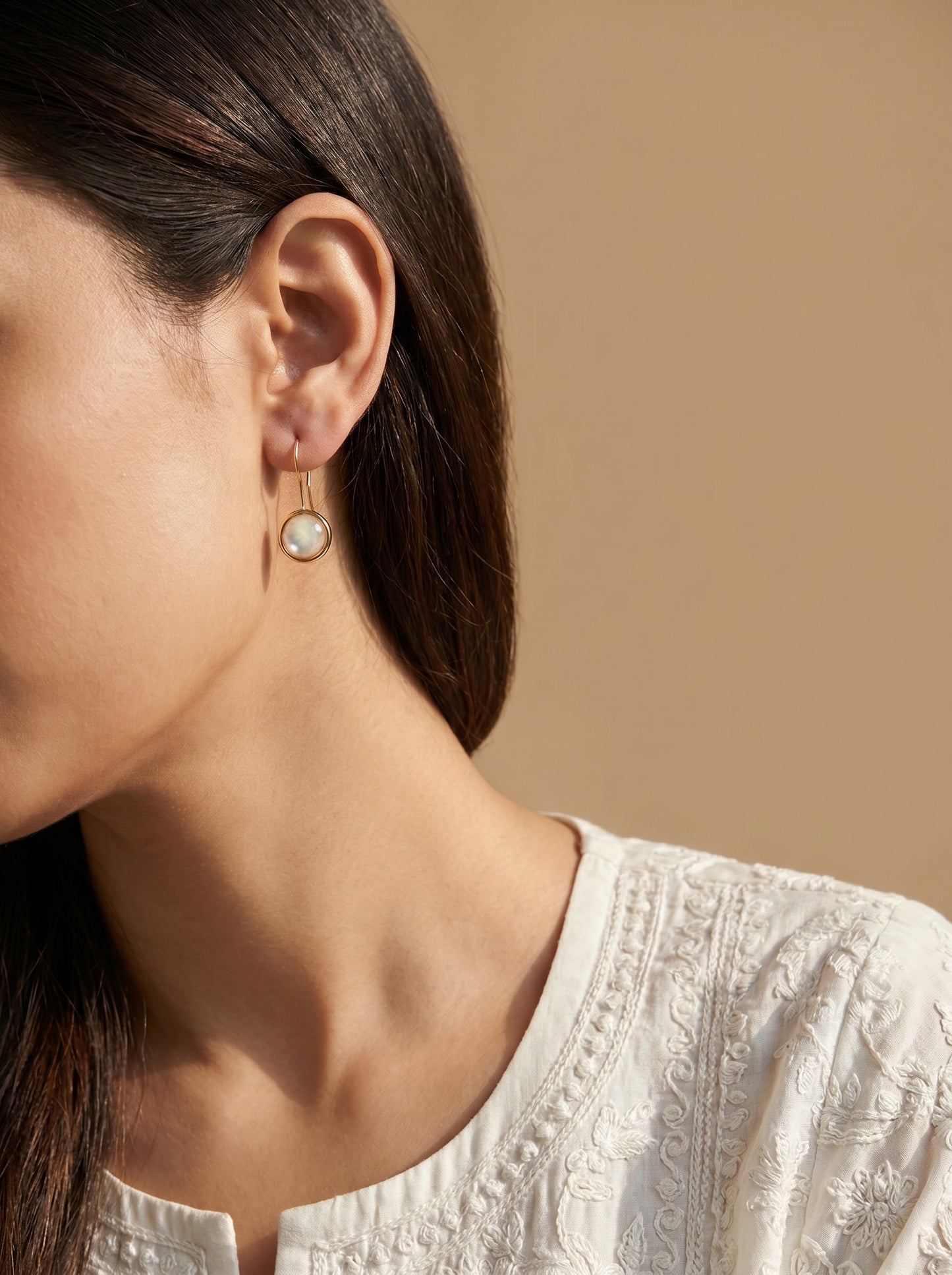 Gold-plated mother of pearl hook earrings lifestyle shot — StoneCraft Jewellery
