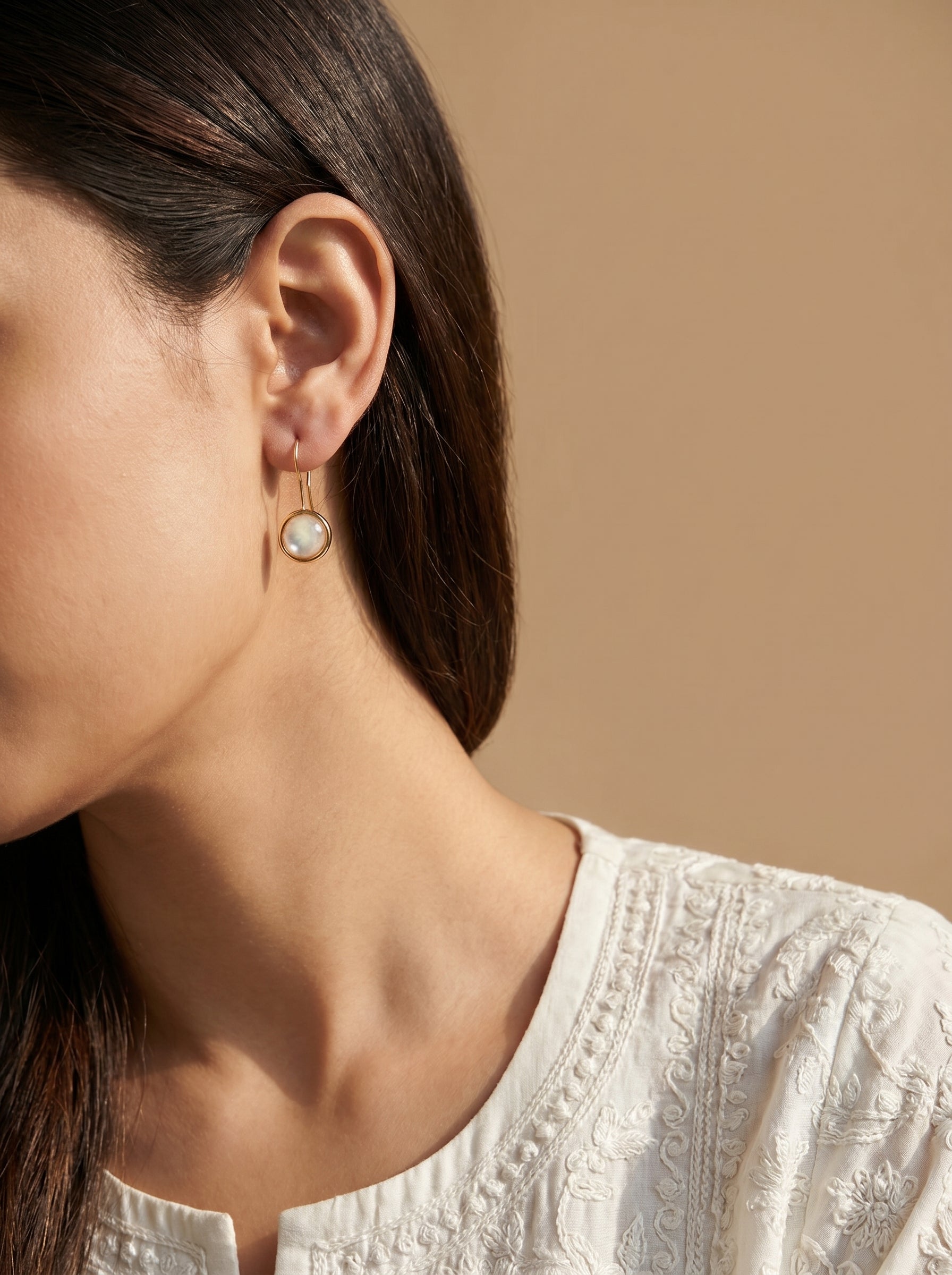 Gold-plated mother of pearl hook earrings lifestyle shot — StoneCraft Jewellery