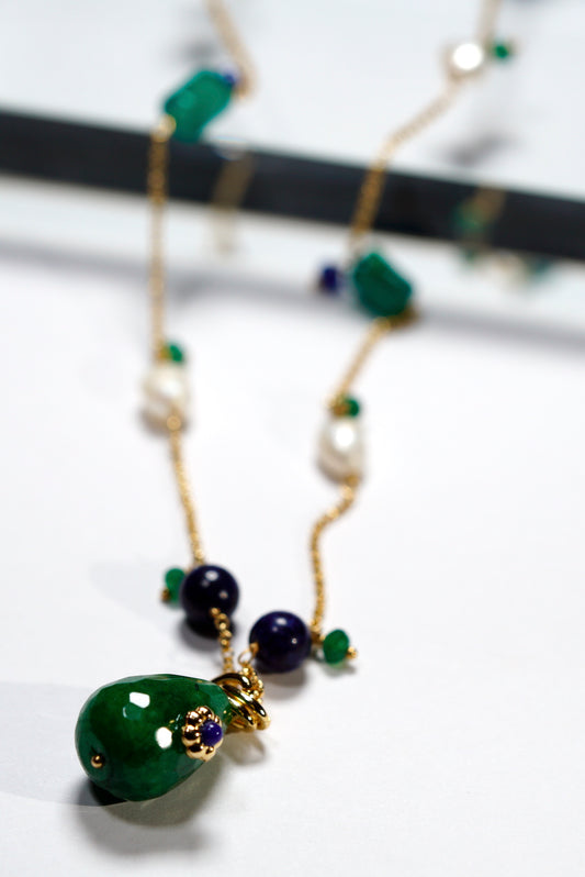 Long Necklace with green  jade and blue beads  and a jade pendant on a white background