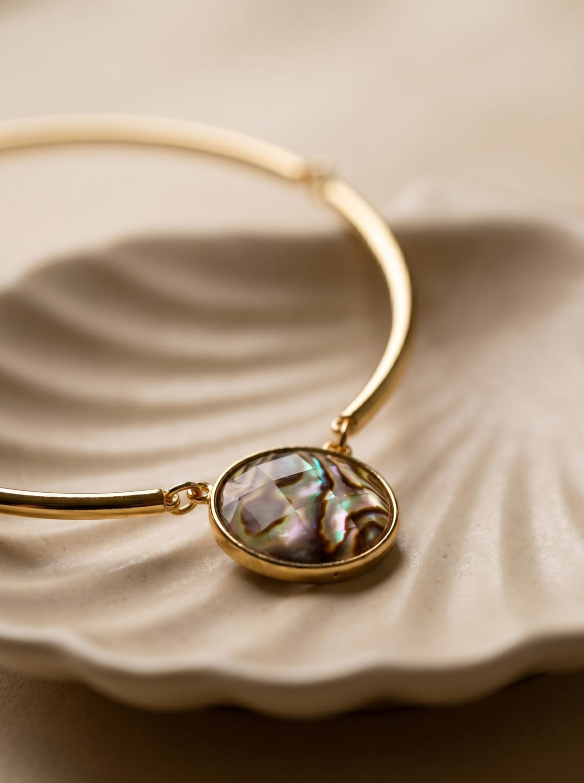 Close-up of abalone shell pendant showing swirling blues, greens and purples — StoneCraft Jewellery