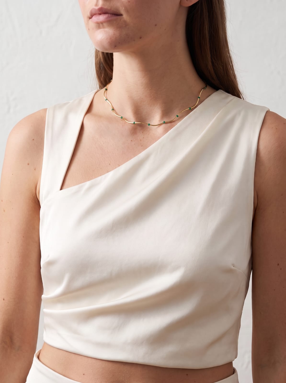 Malachite Bead Chain Necklace gold-plated worn on model with cream asymmetric top — StoneCraft Jewellery